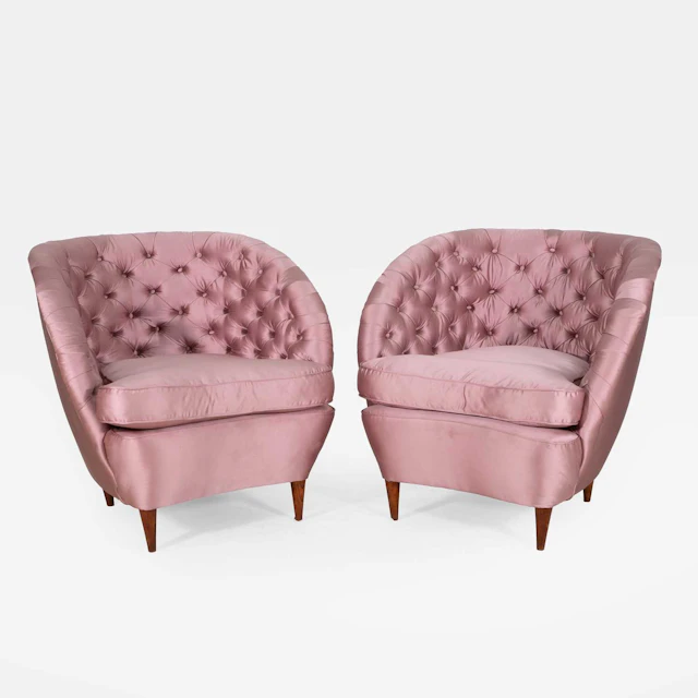A pair of pink buttoned armchairs circa 1930s