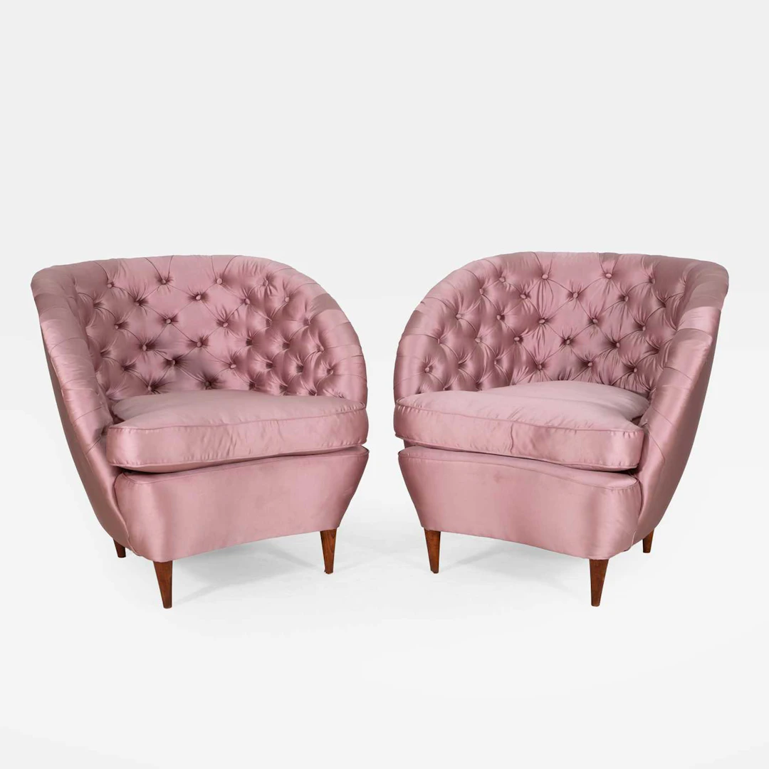 A pair of pink buttoned armchairs circa 1930s