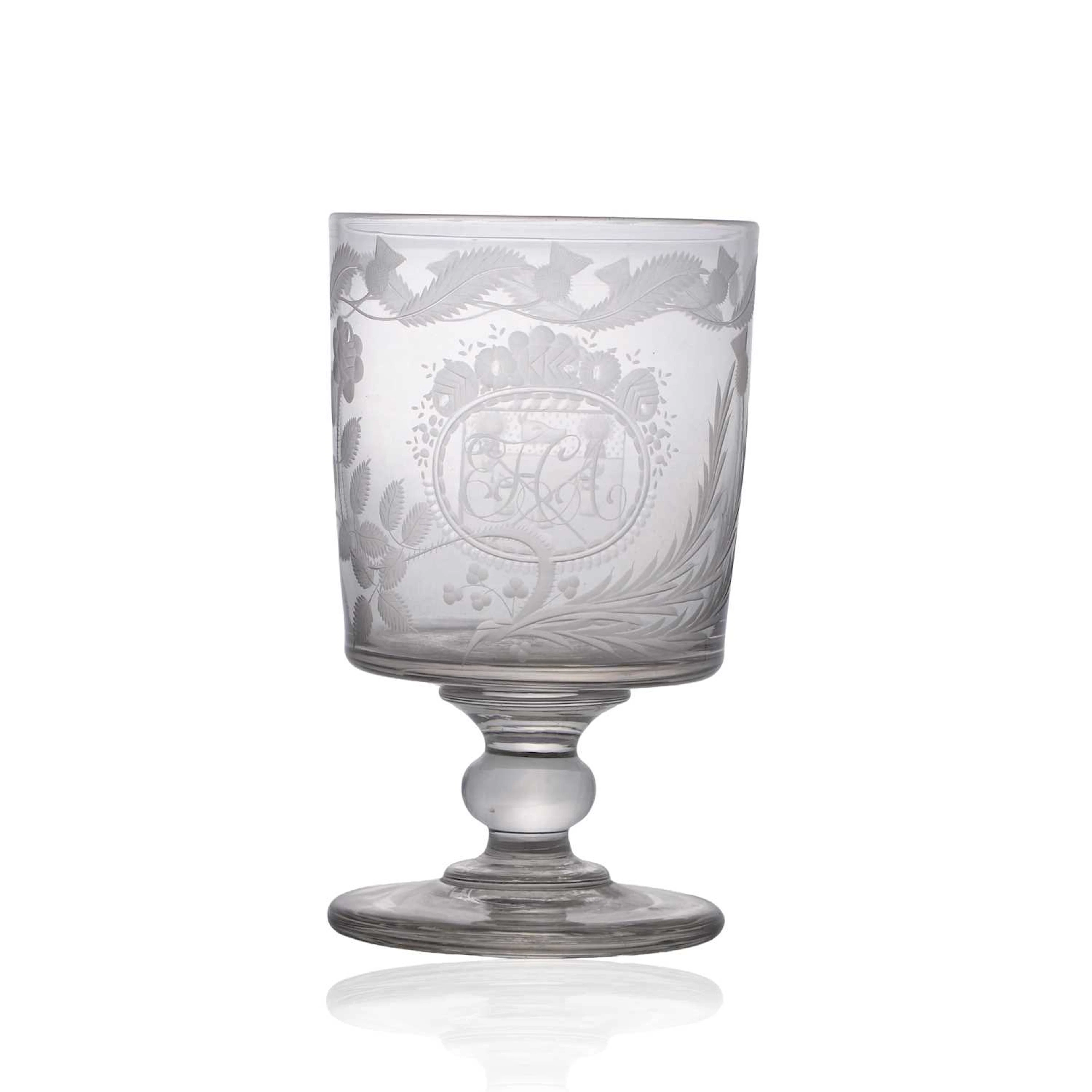 An oversized engraved glass rummer circa 1810