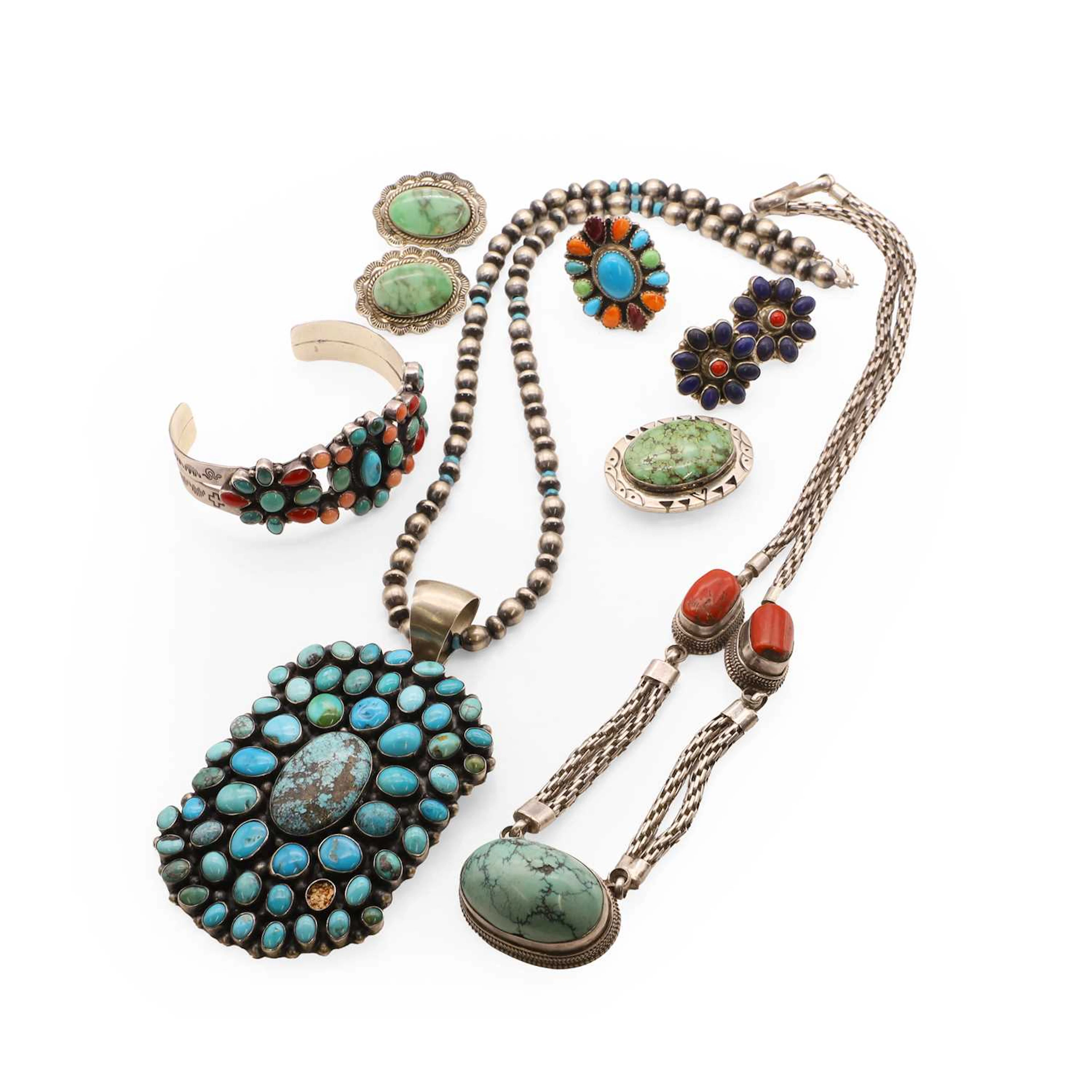A collection of silver turquoise and gemstone set Navajo jewellery