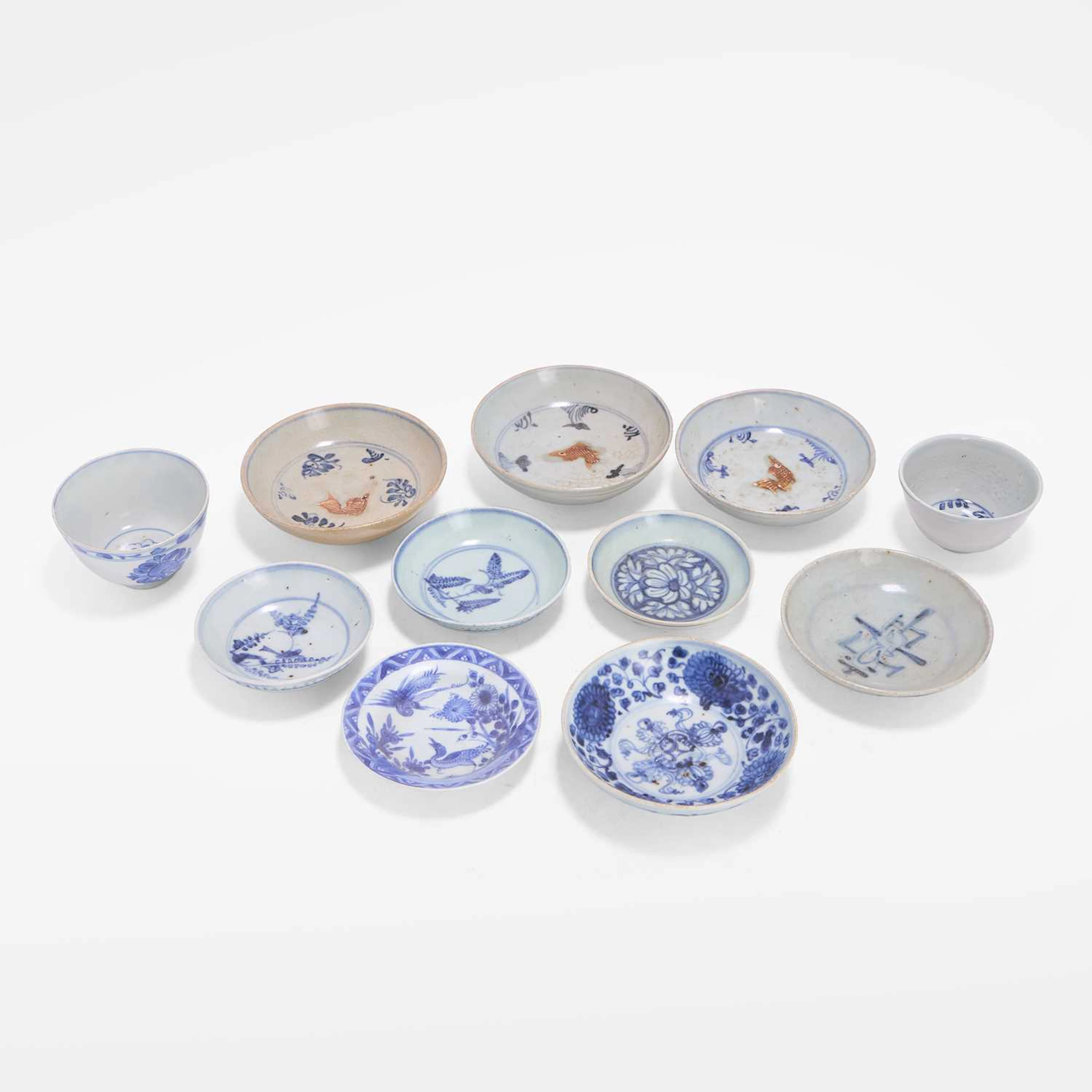 A collection of eleven Chinese blue and white cups and saucers Ming