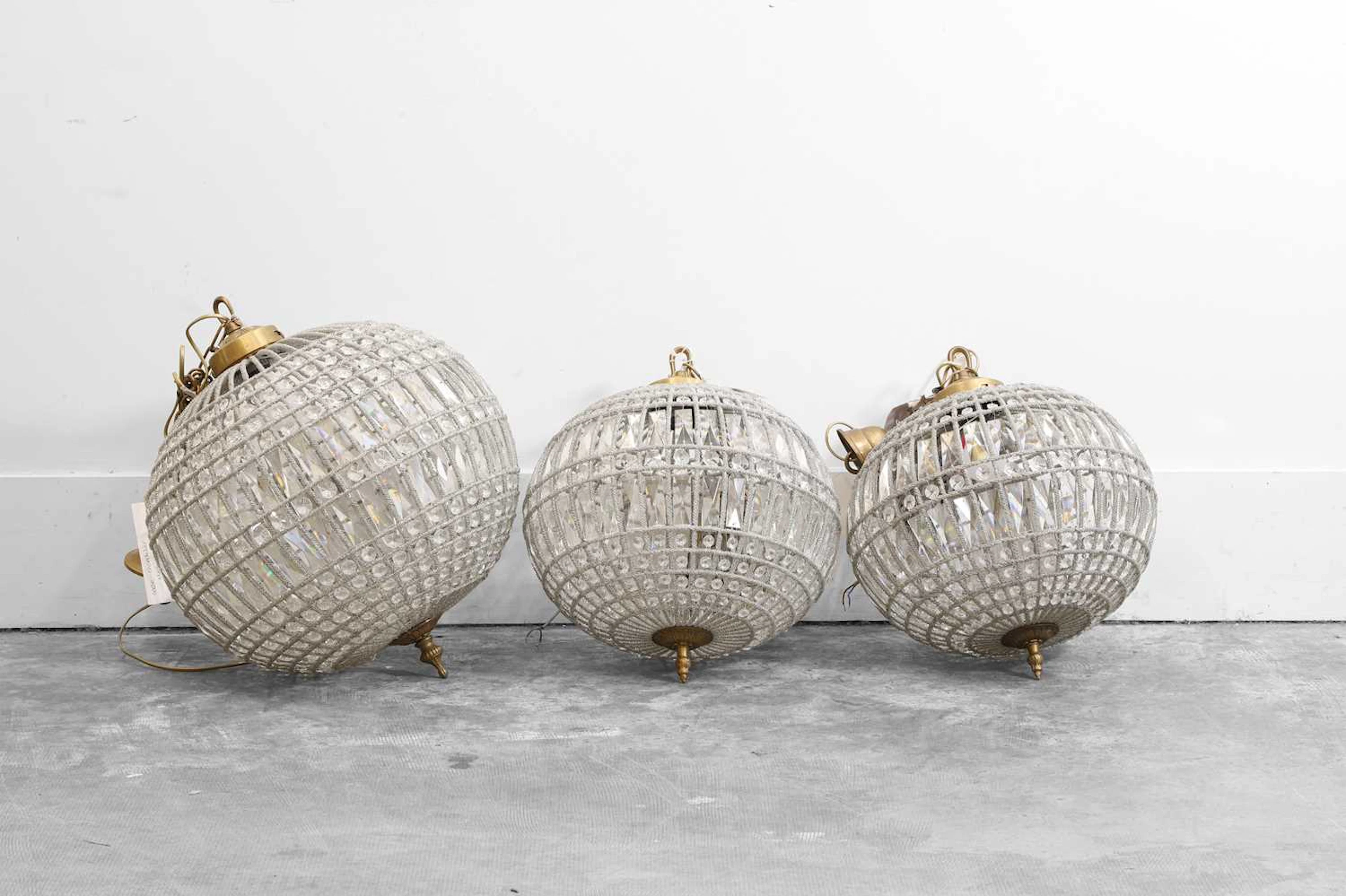 A group of three cut-glass globe chandeliers of recent manufacture