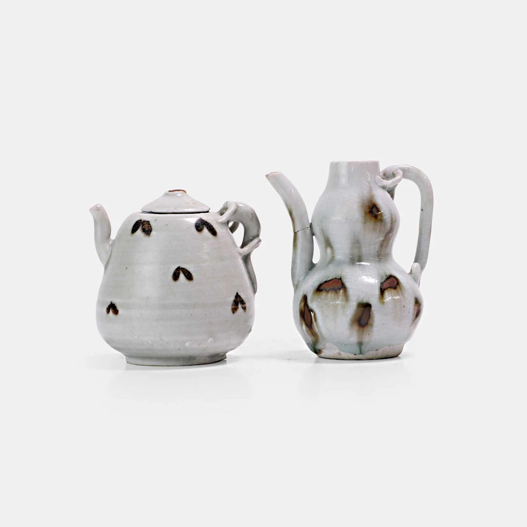 Two Chinese iron-spot-decorated qingbai-glazed ewers Yuan dynasty (1271-1368)