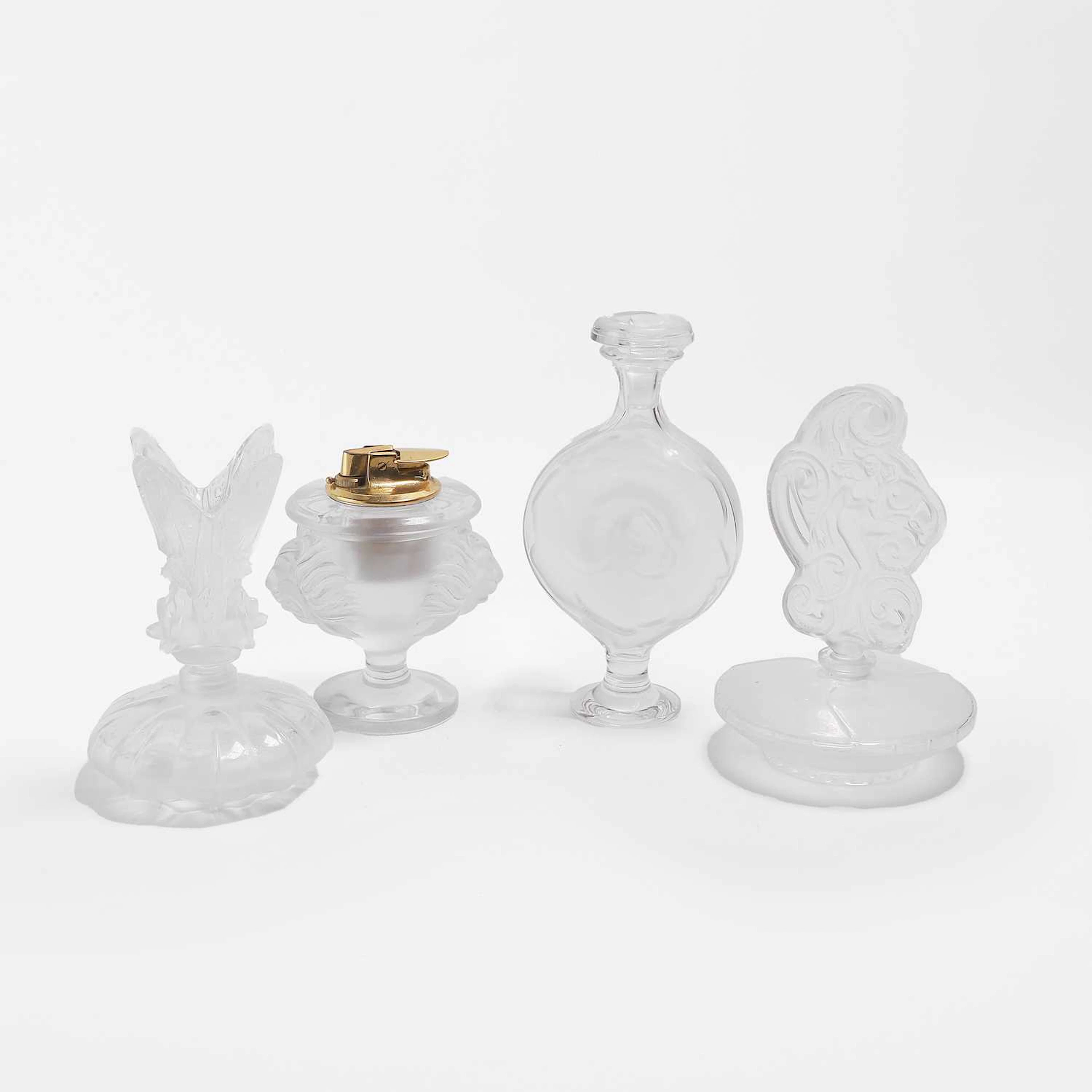 A group of three Lalique glass scent bottles