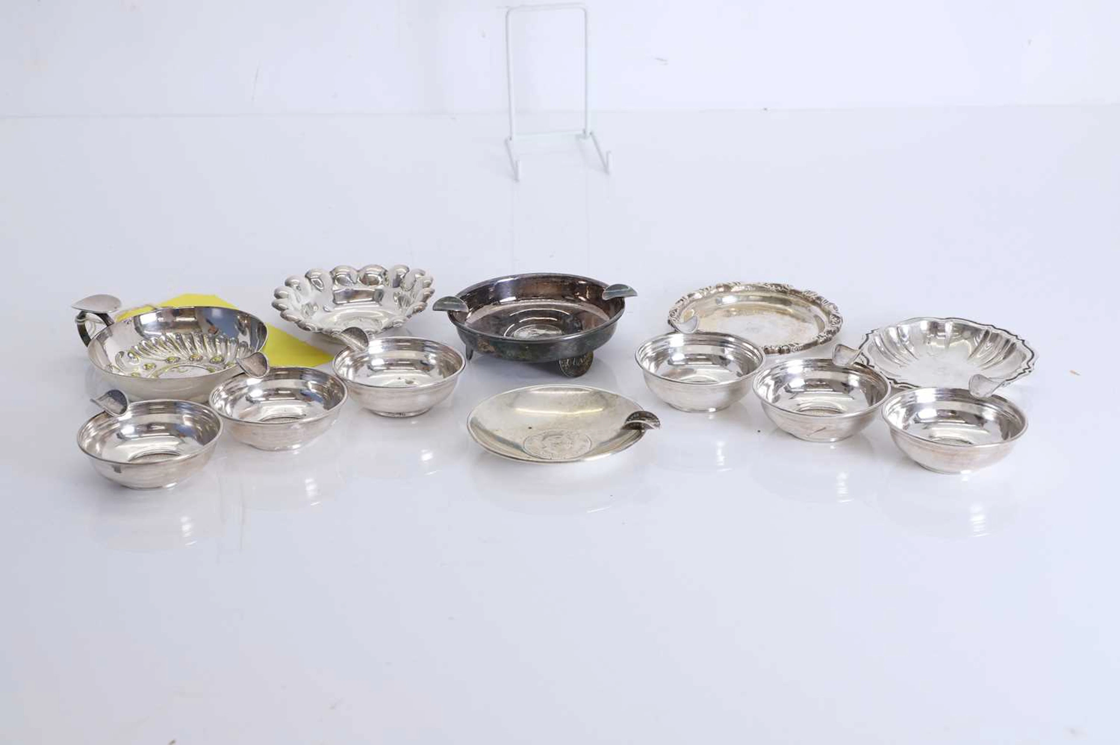 A collection of six silver tastevins