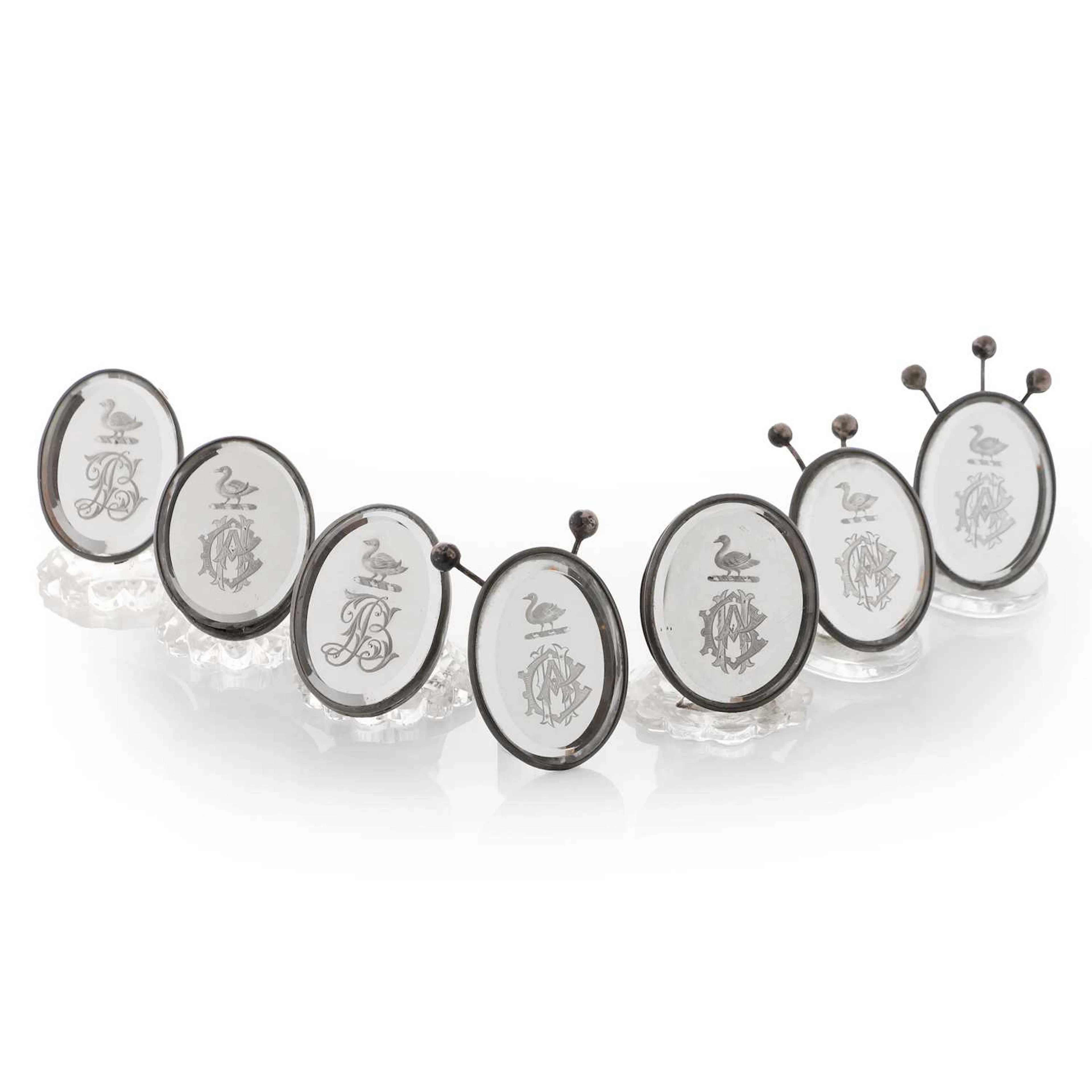 A composed set of seven reverse-engraved and mirrored-glass menu holders