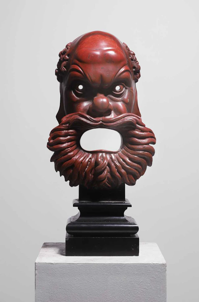 Manner of Benedetto Boschetti A carved rosso antico marble mask