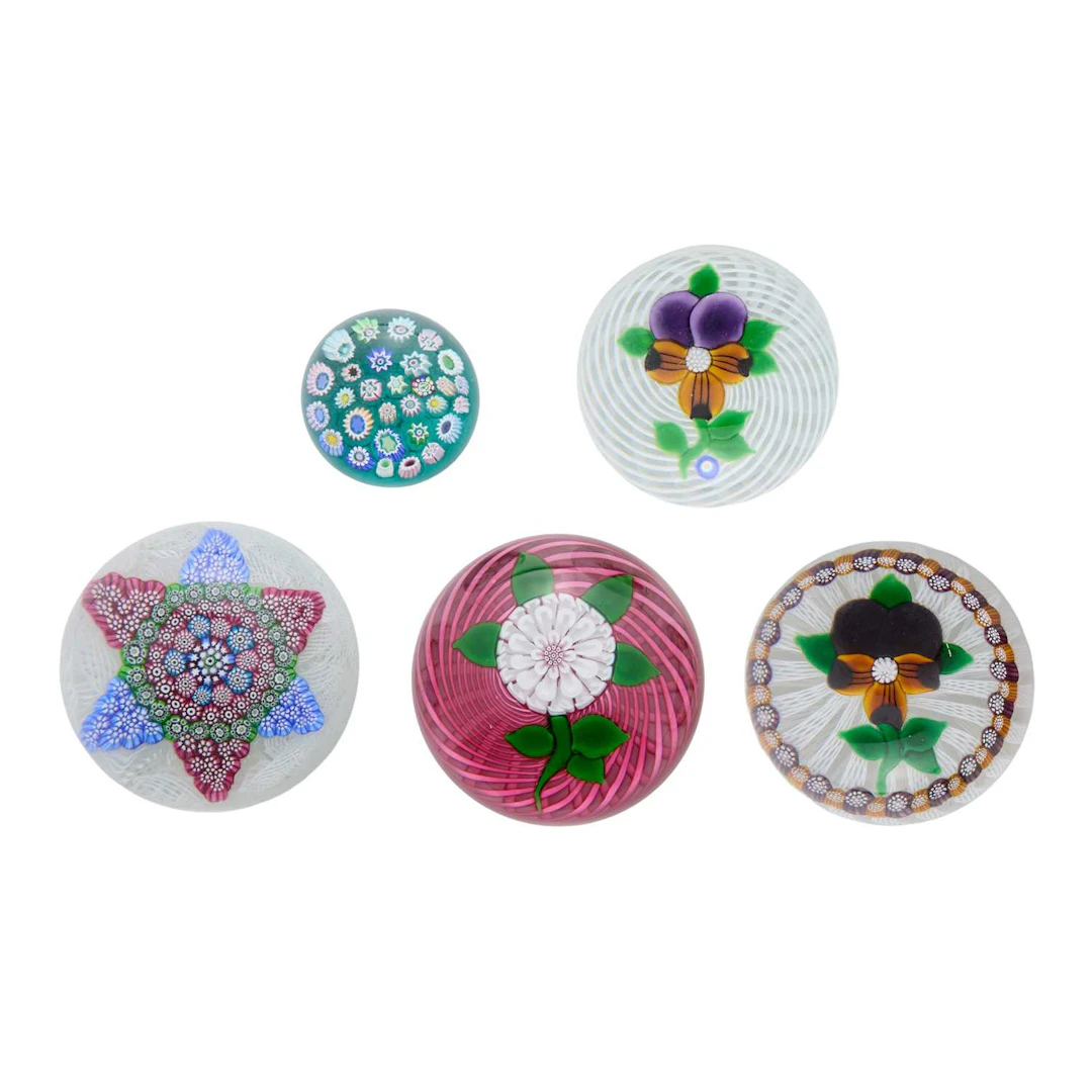A collection of five John Deacons glass paperweights 1990 and later