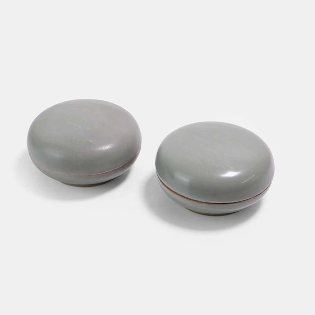 A pair of Chinese celadon-glazed boxes and covers possibly Song dynasty