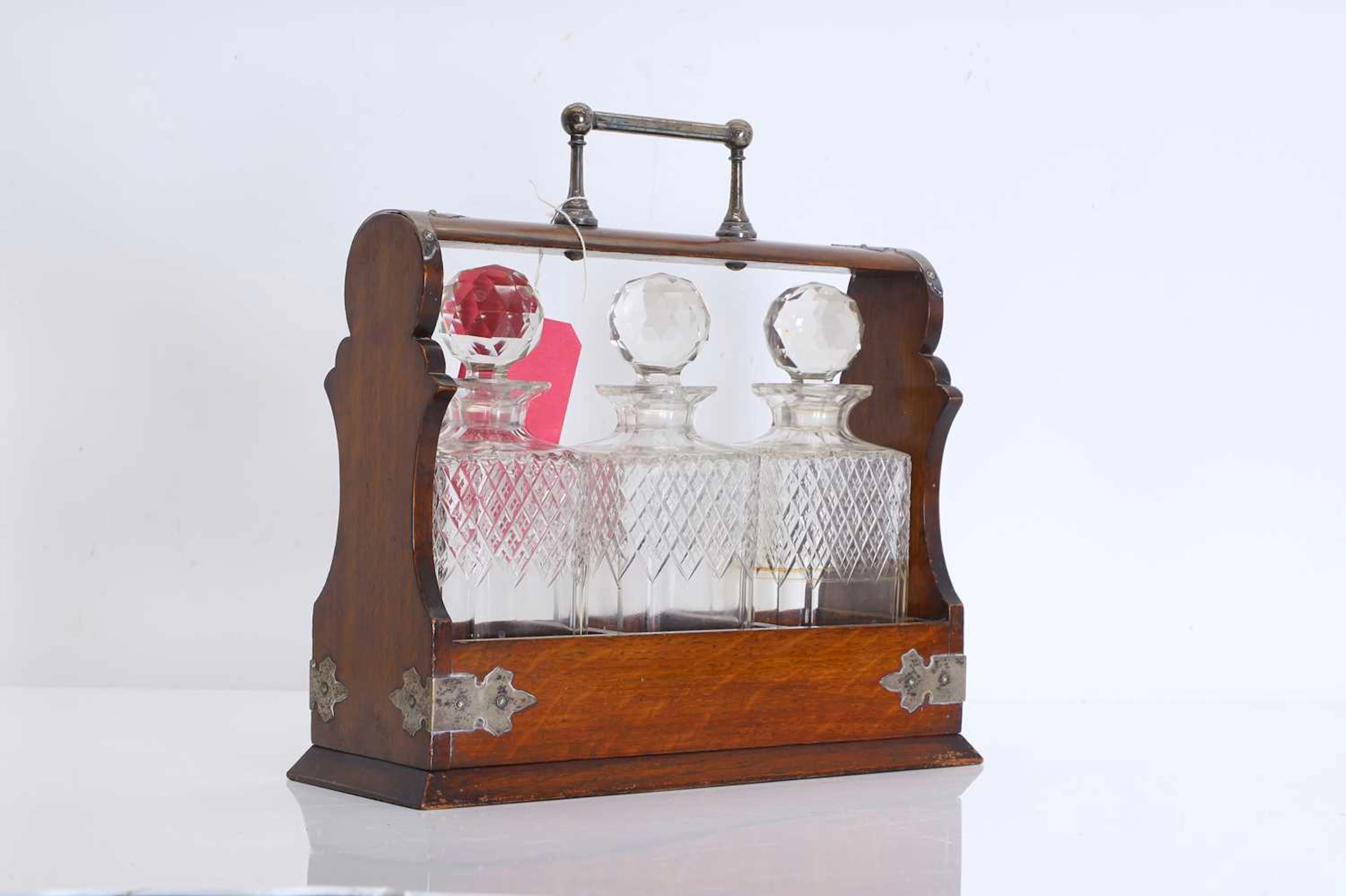 A Victorian three bottle cut glass tantalus Late 19th century