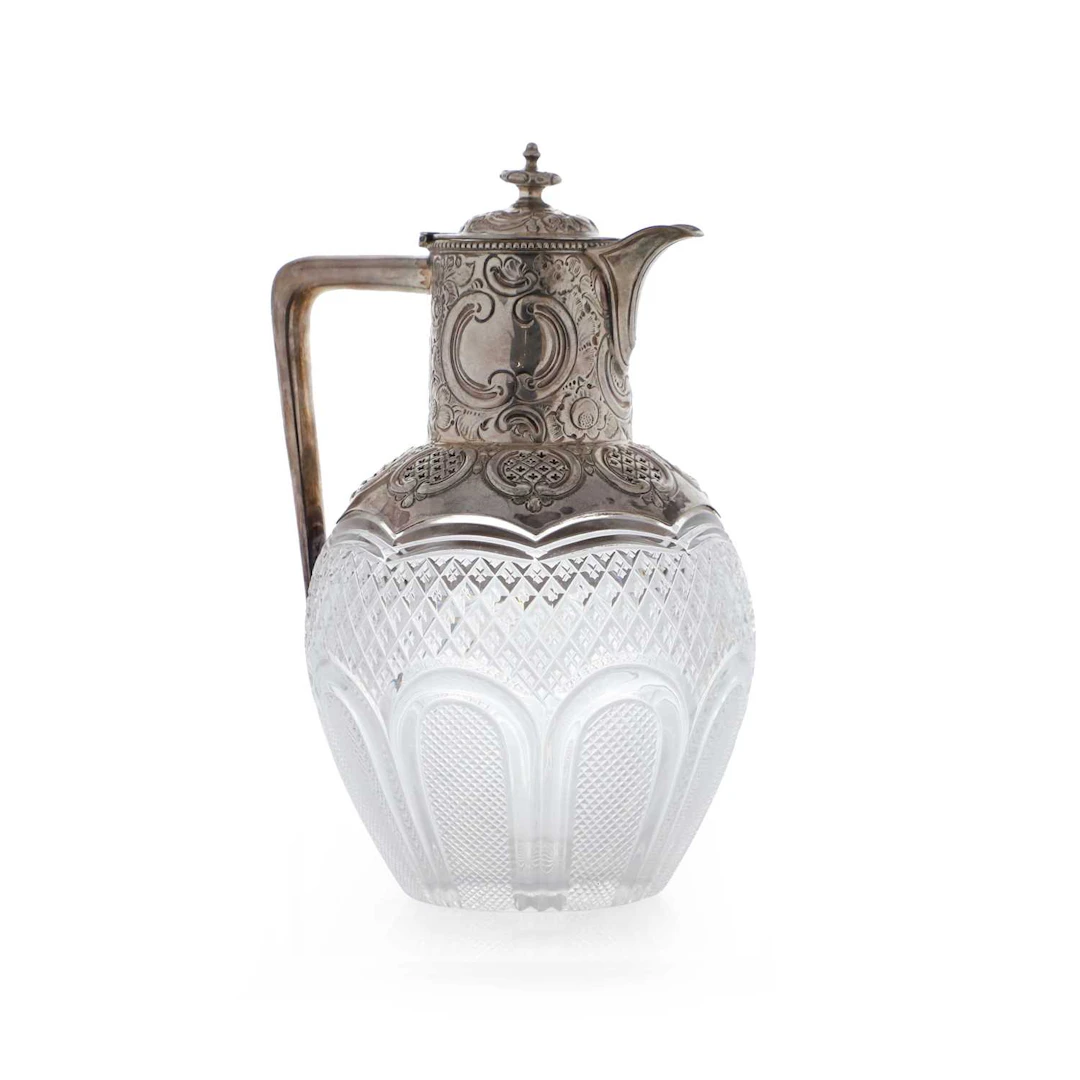 A late Victorian cut-glass and silver-mounted claret jug the mounts