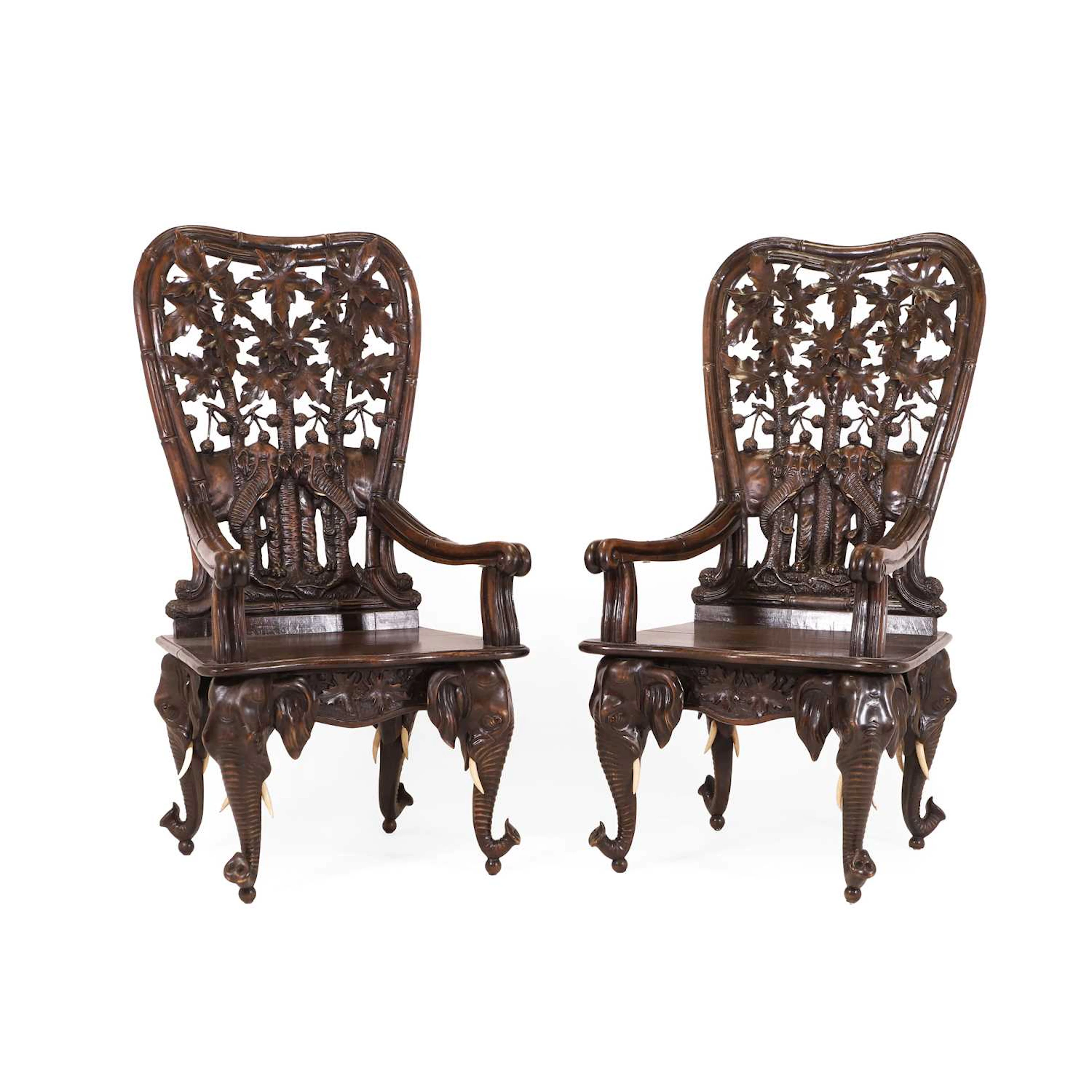 A pair of carved linden wood Black Forest elbow chairs c.1900, Swiss