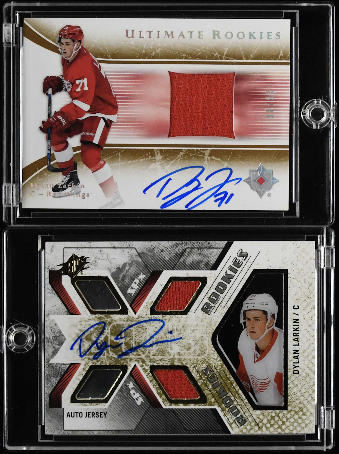 "Lot of (2) Dylan Larkin signed serial numbered rookie relic cards (NM-NM/MT)