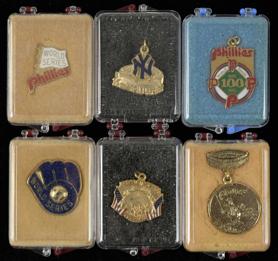"Lot of (8) World Series press pins and charms from 1980-1984 (EX-NM/MT)