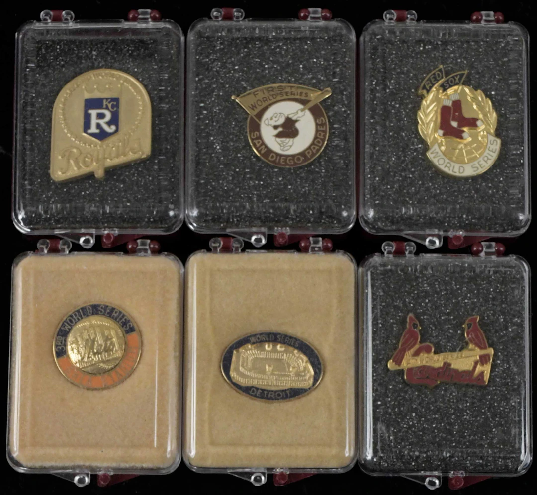 "Lot of (9) World Series press pins from 1980-1986 (EX/MT-NM/MT)