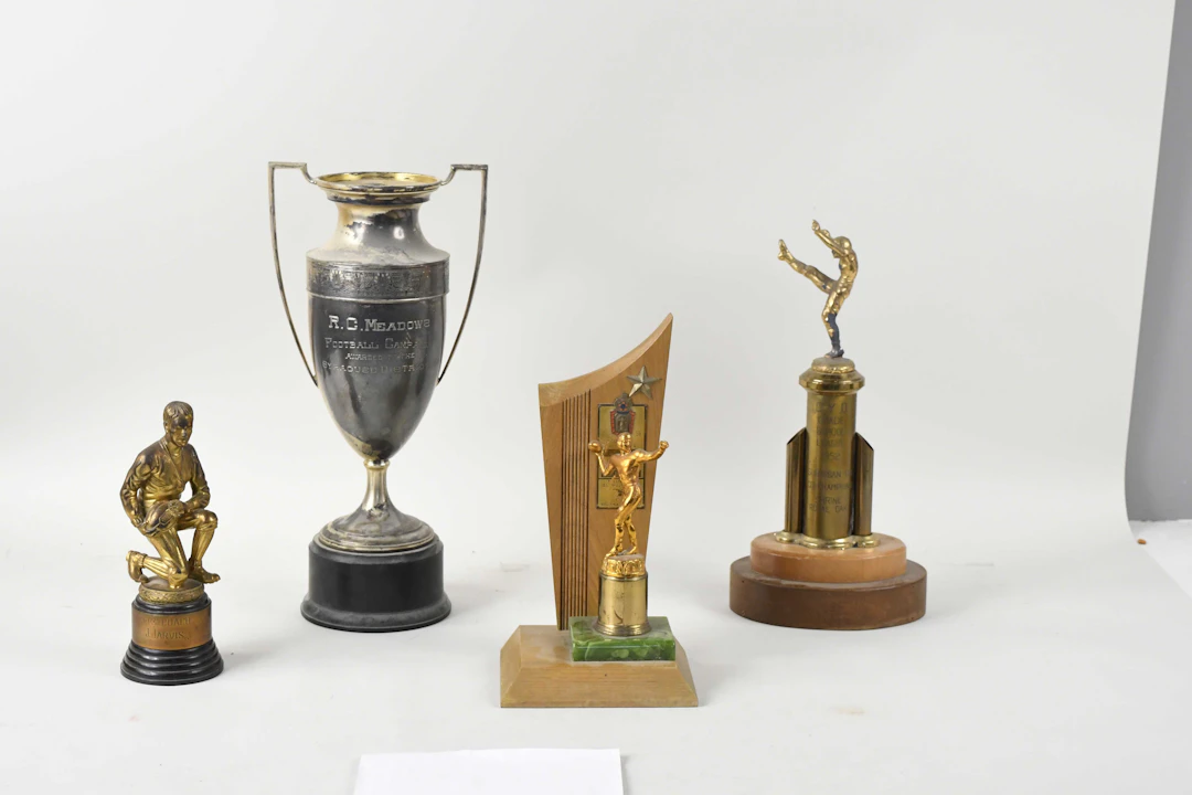 "Lot of (5) football trophies from 1938-1956 (GD-VG/EX)