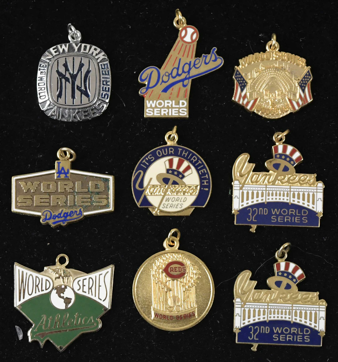 Lot of (9) 1976-1990 World Series press charms (EX-NM)...