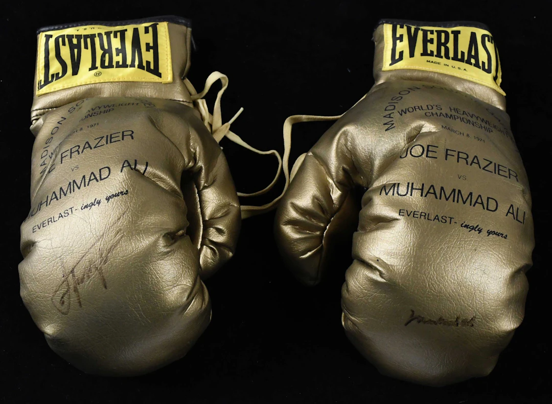 "Muhammad Ali and Joe Frazier signed 1971 commemorative boxing gloves (EX/MT-NM)