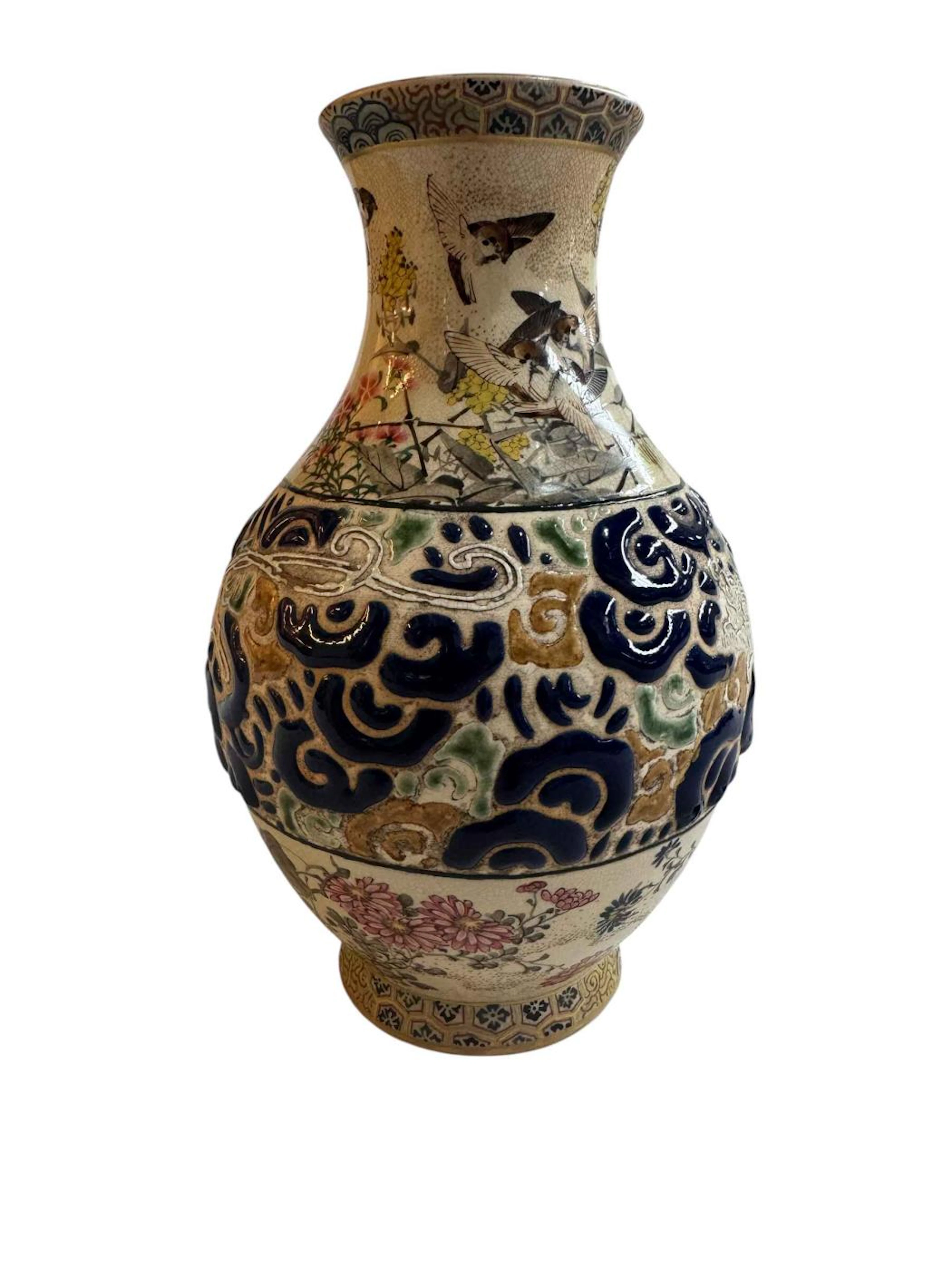 Chinese ceramic vase with floral and bird design and central raised