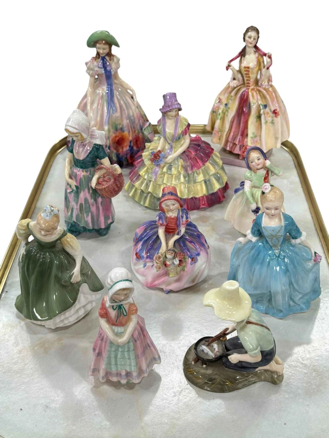 Ten Royal Doulton figures including Easter Day, Annette, Tootles and Rover Boy.