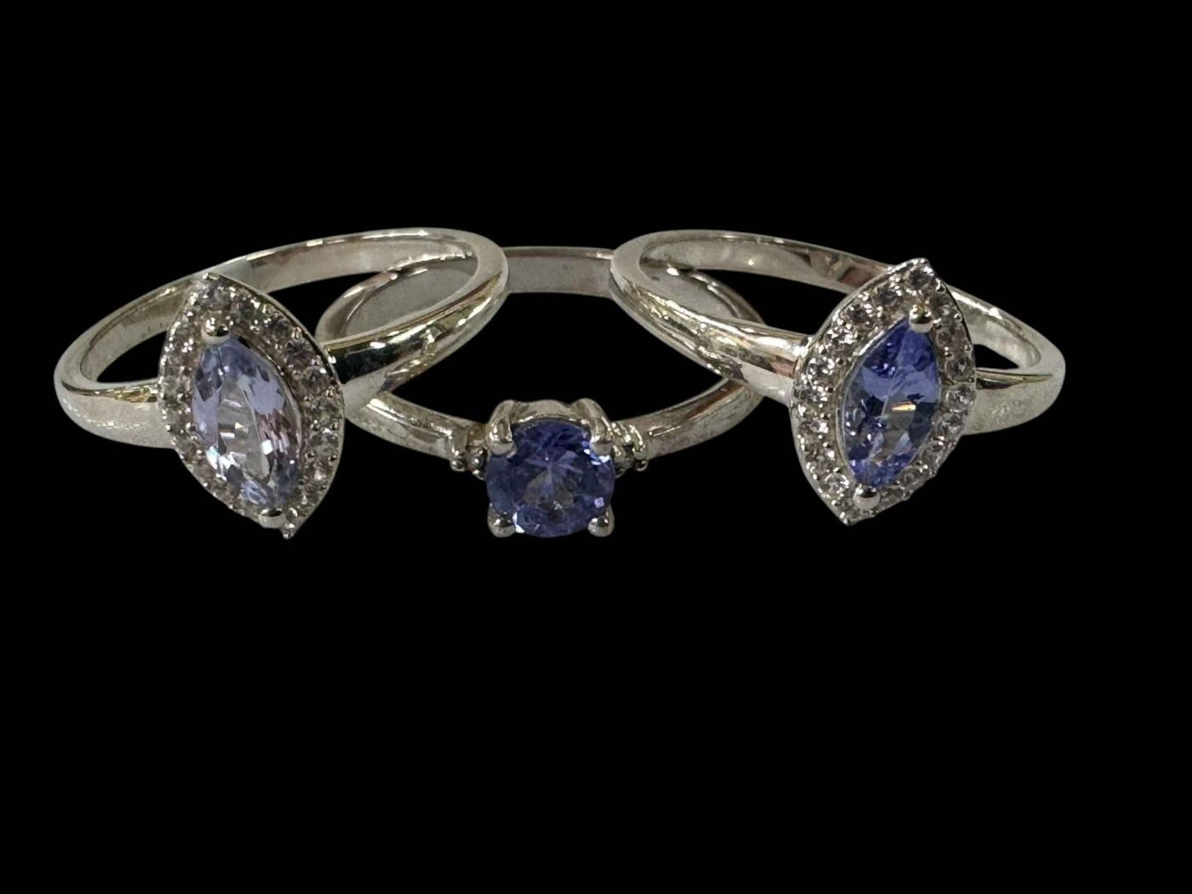 Three tanzanite set silver rings, sizes S.