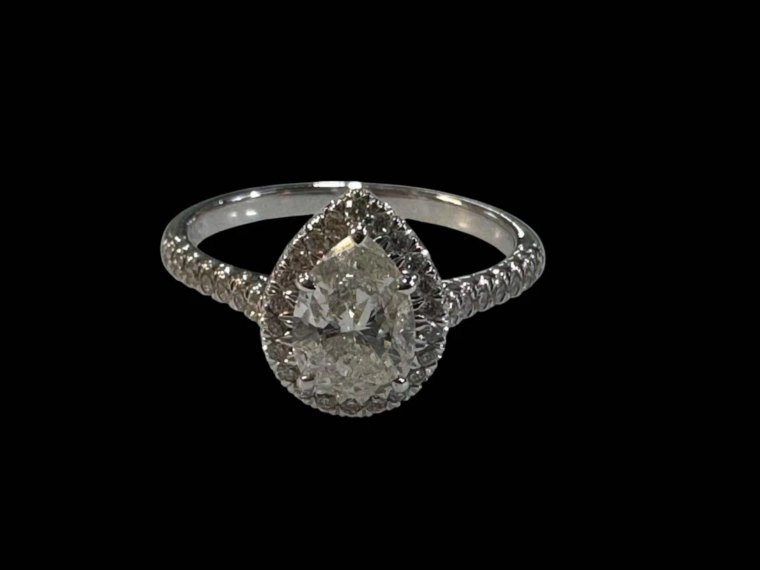Pear shaped diamond cluster ring set in 18 carat white gold, size N.