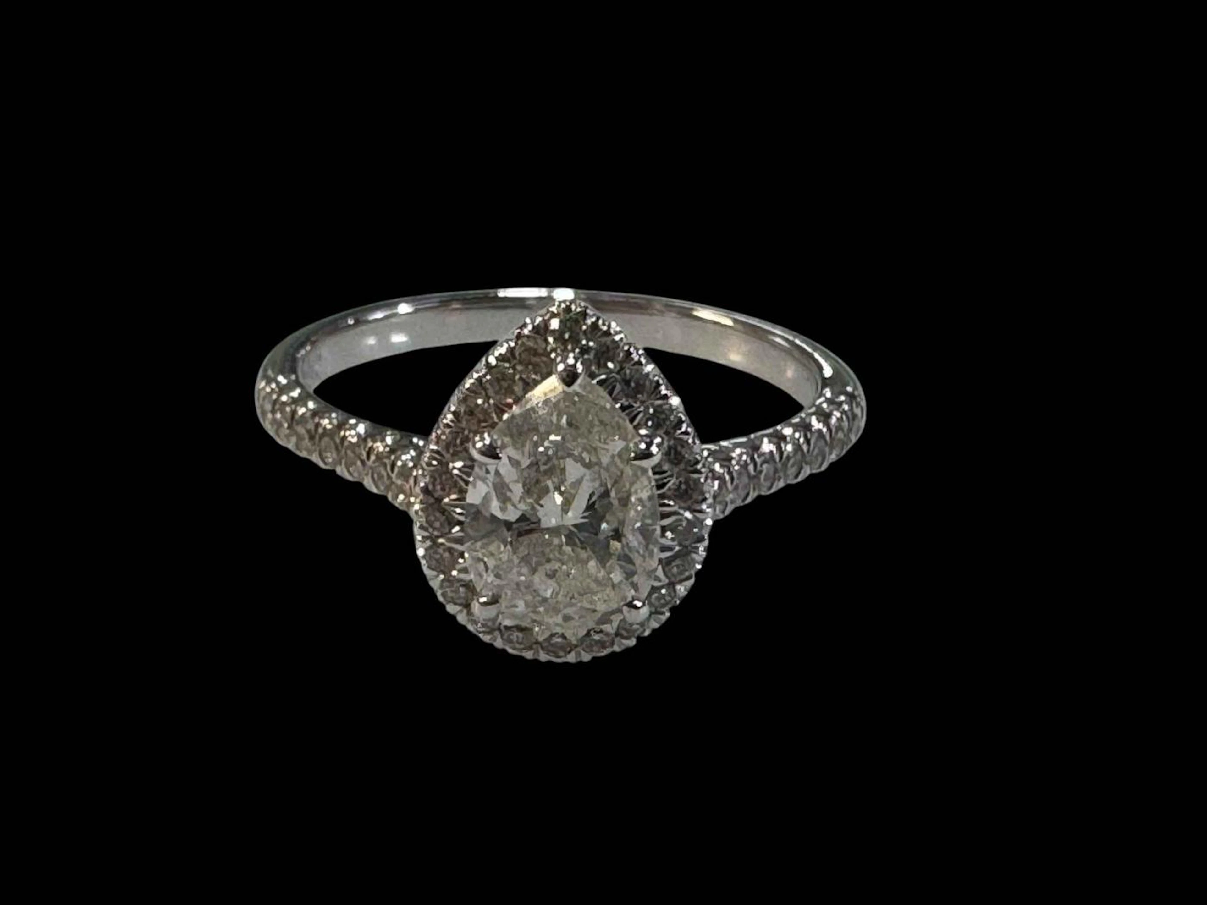 Pear shaped diamond cluster ring set in 18 carat white gold, size N.