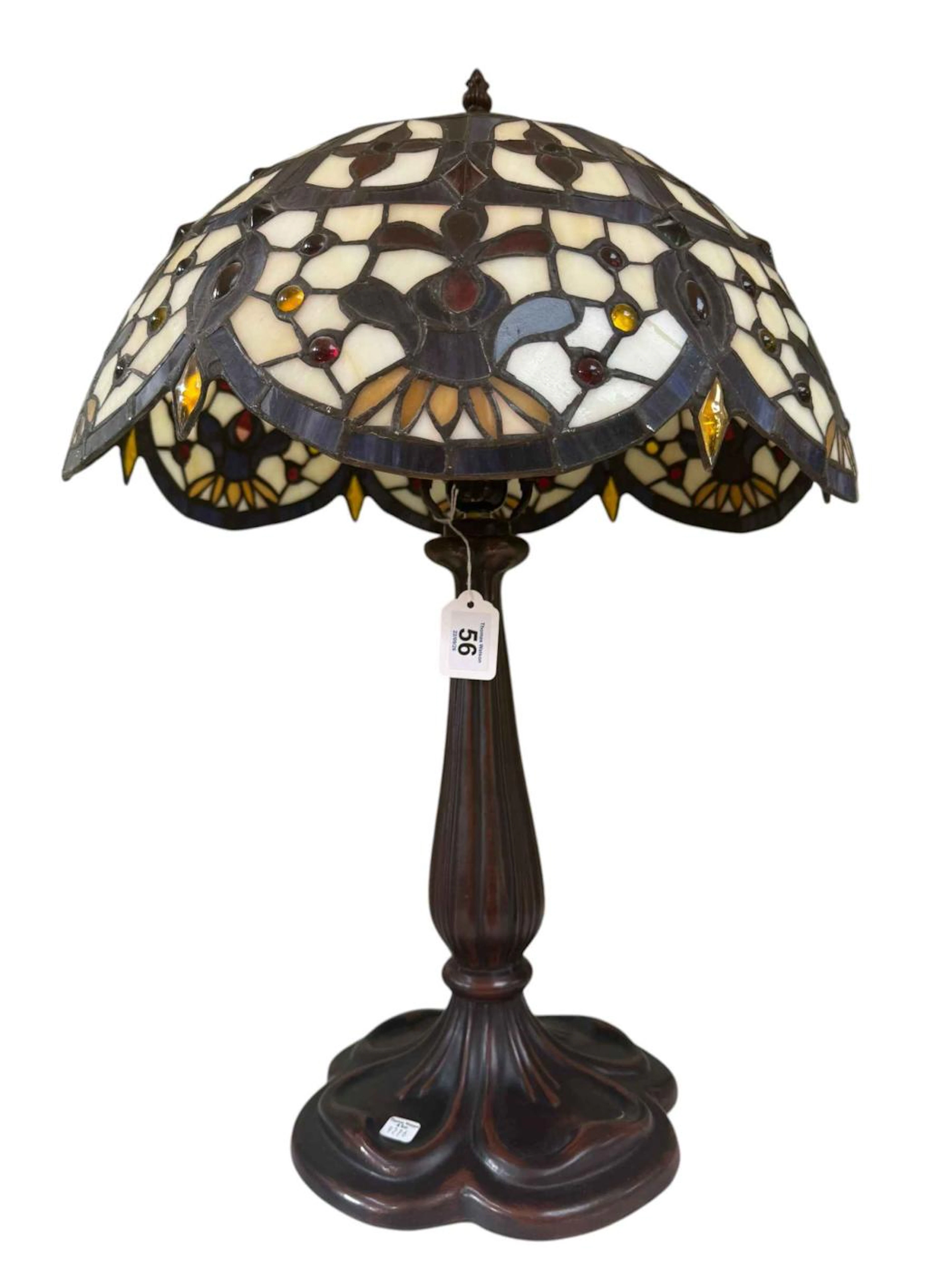 Tiffany style table lamp featuring a scalloped blue and white pattern design.