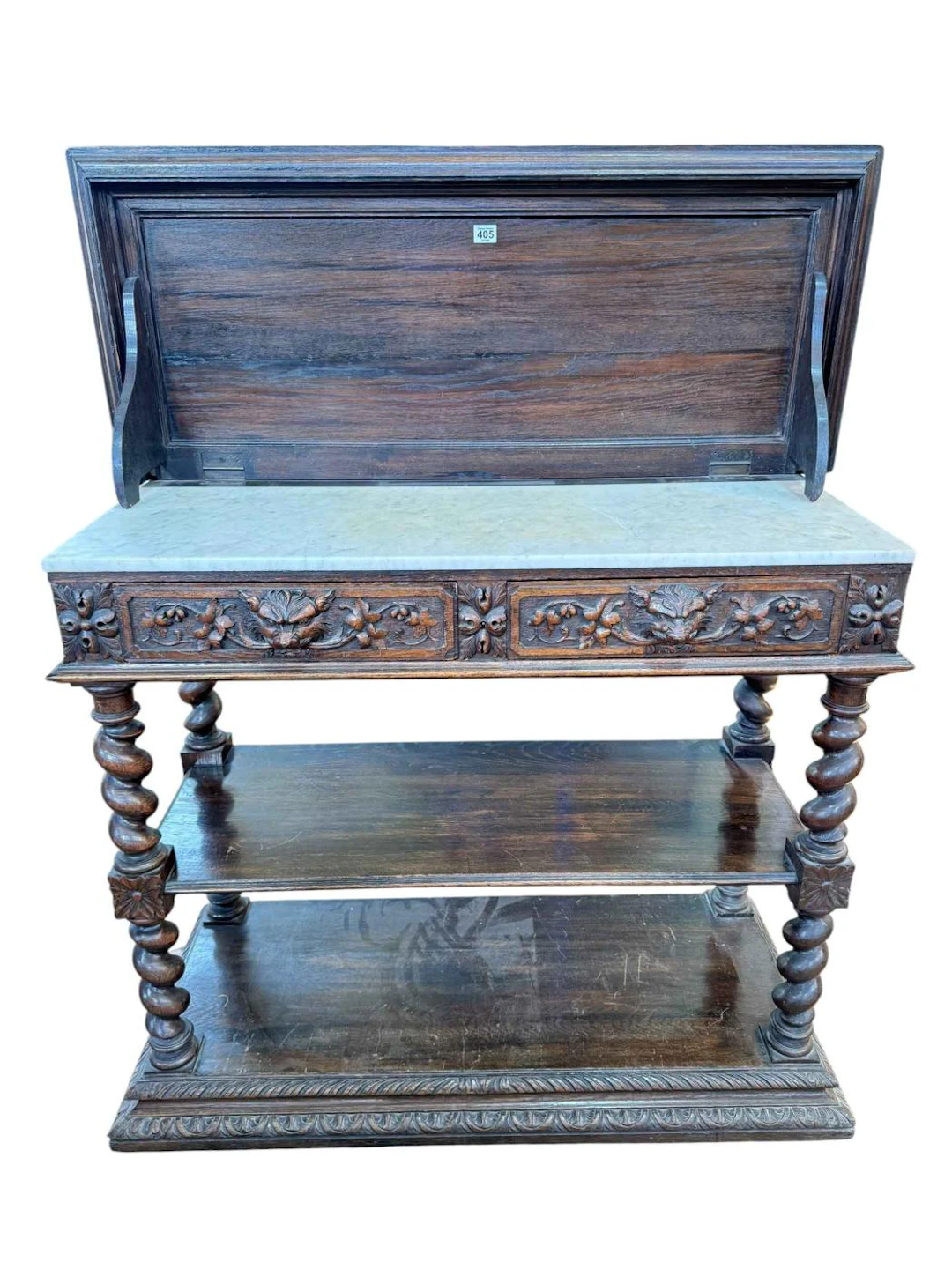 Carved oak buffet raised on four barley twist columns, having two