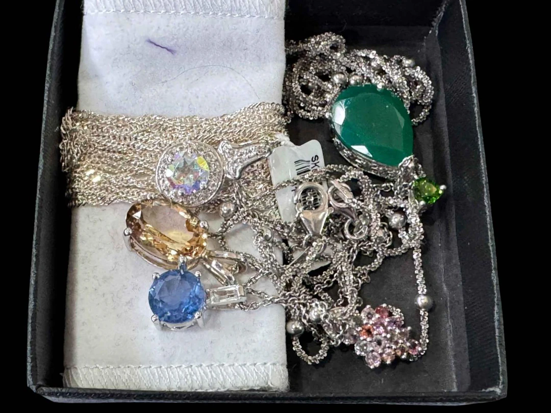 Collection of silver chains, pendants, etc.