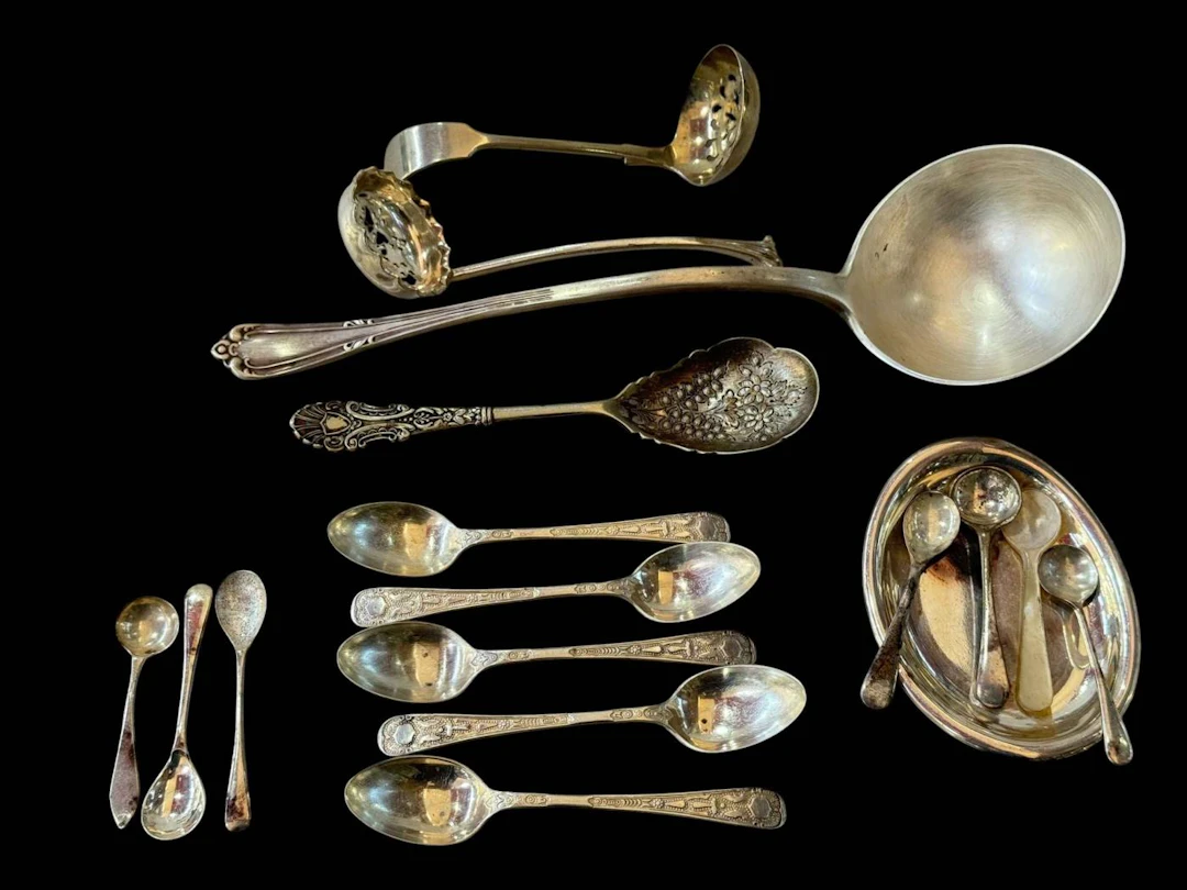 Silver soup ladle, five silver coffee spoons, silver spoon, and other EP items.