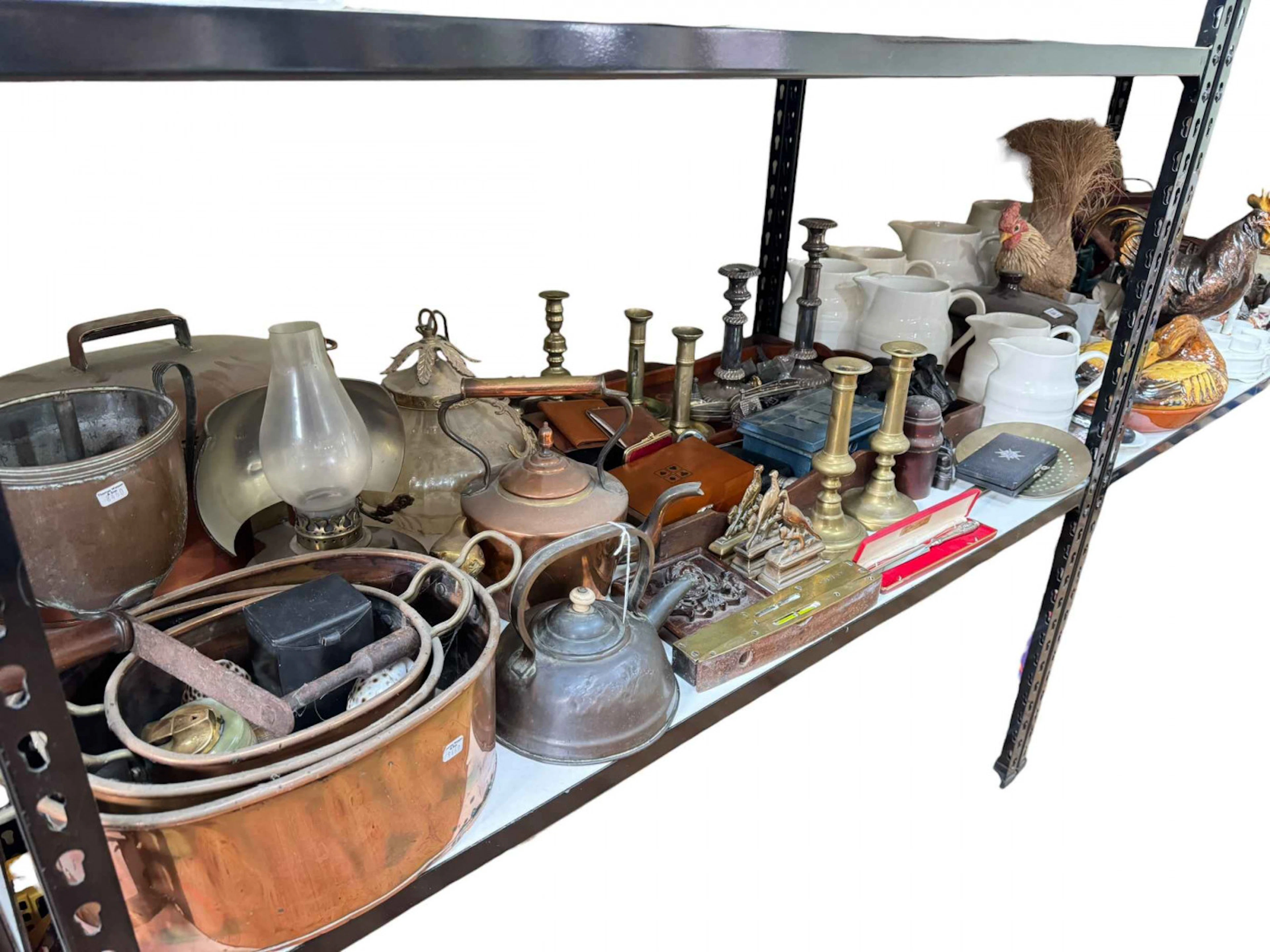 Large collection of metalwares including copper pans and candlesticks