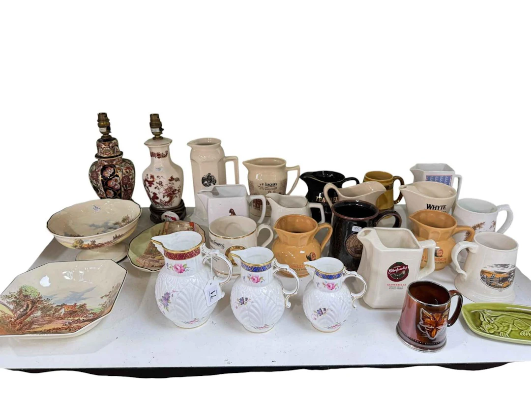 Three graduated Copeland Spode mask jugs, whisky water jugs, three