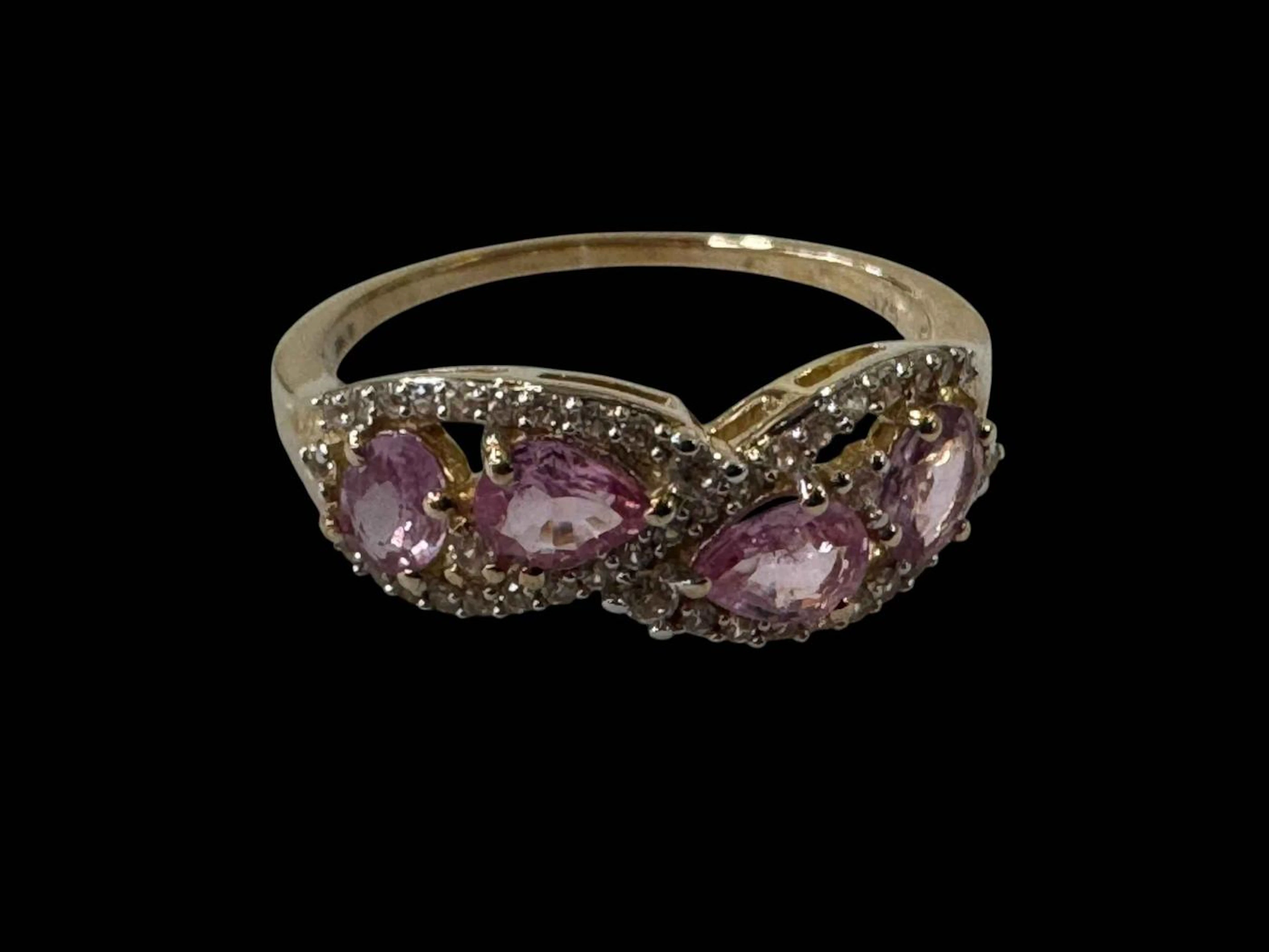 Pink sapphire four stone 9k gold ring, size P/Q.