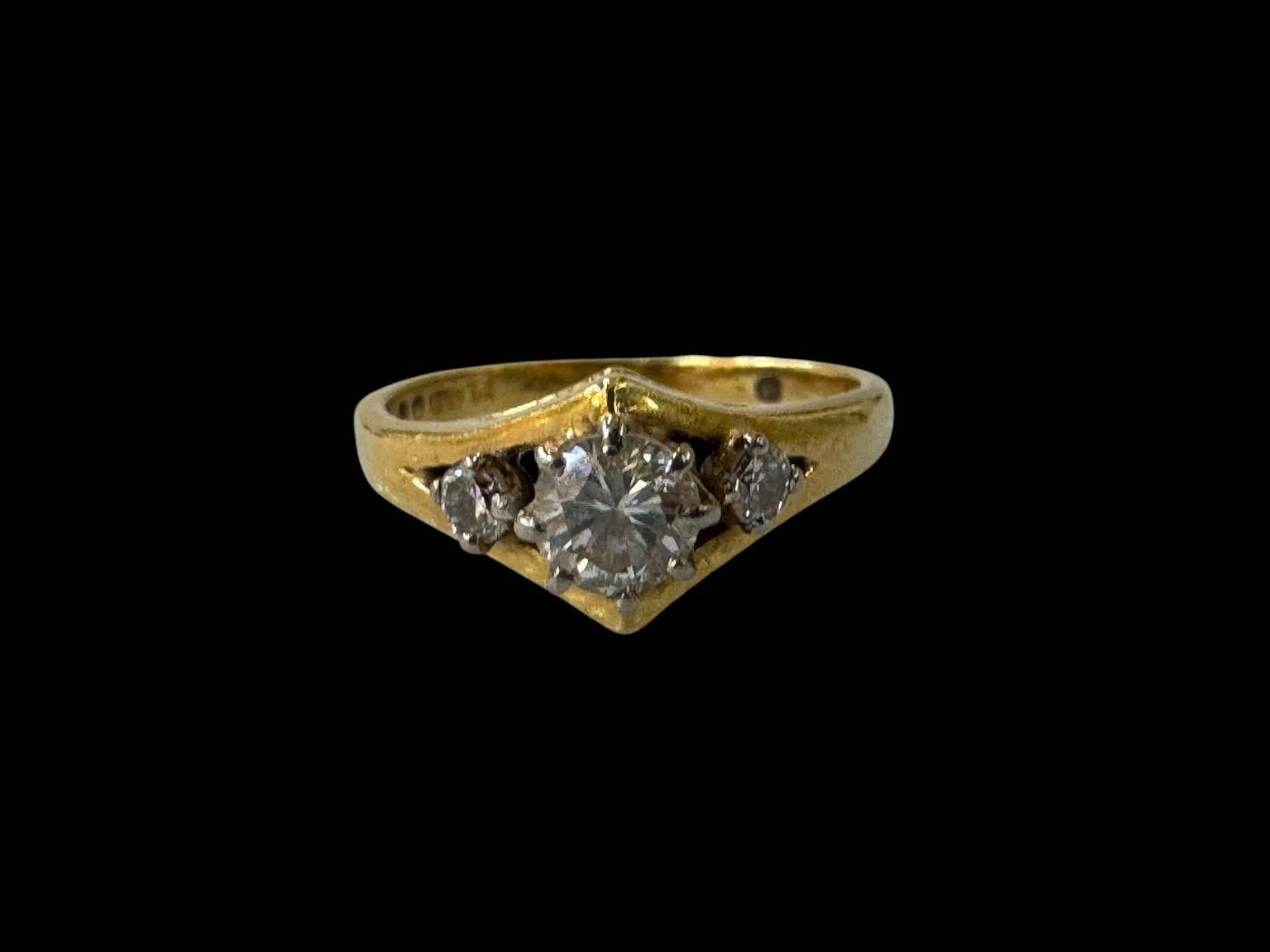 Child's diamond three stone 18 carat gold ring, size F.