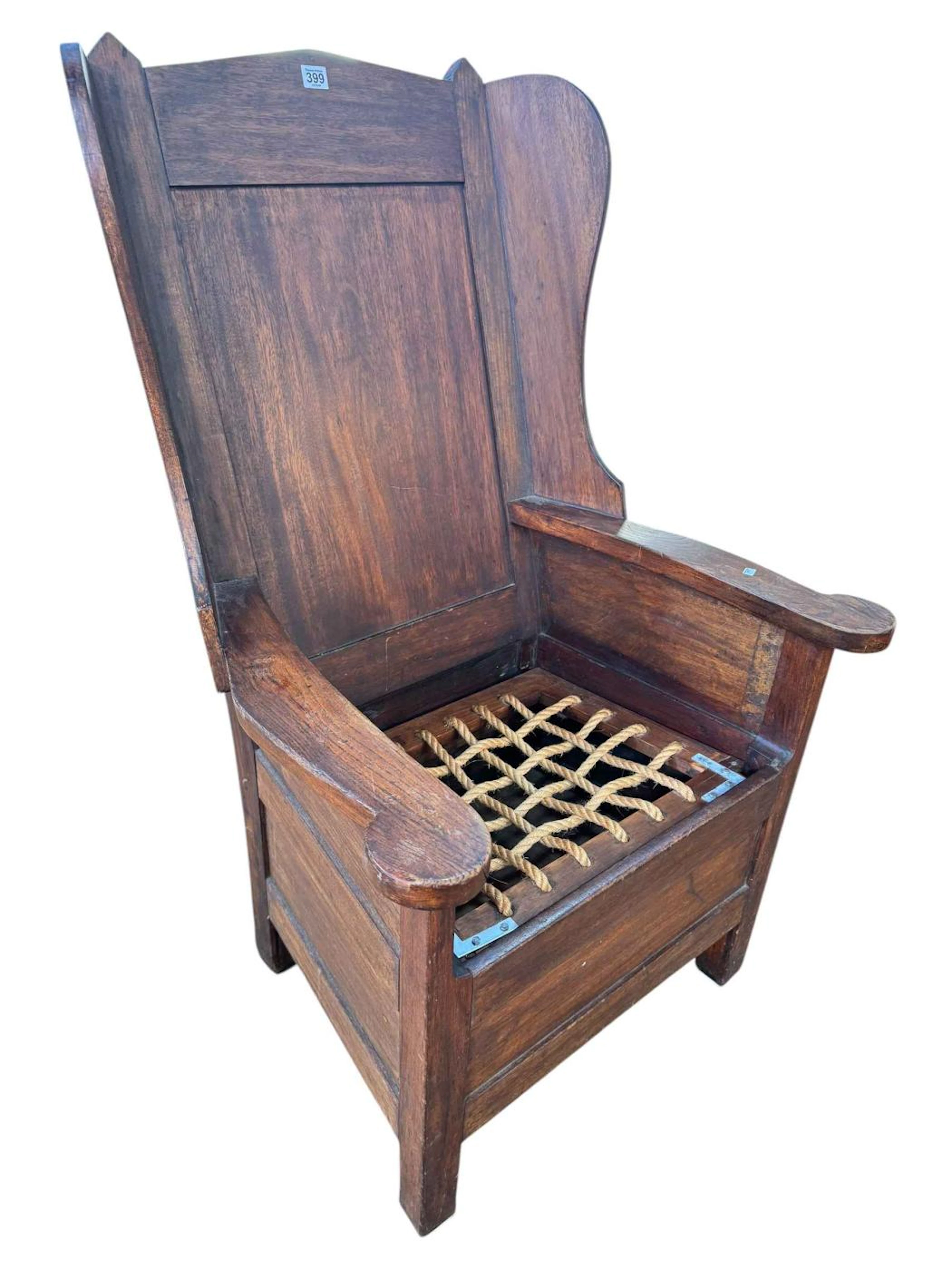 Antique lambing chair with rope seat and fielded panel back.