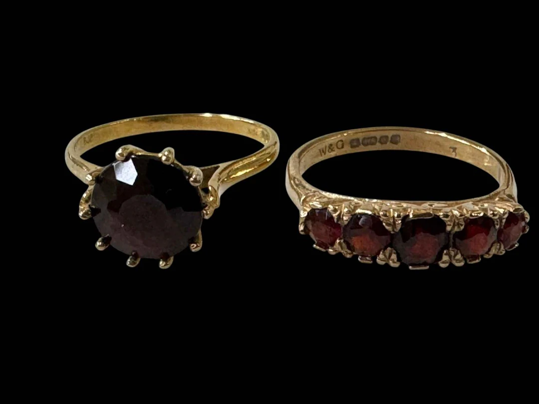 Two garnet set 9 carat gold rings, both size N.