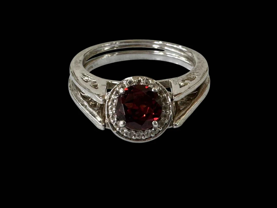 Two garnet set silver rings, one double sided.