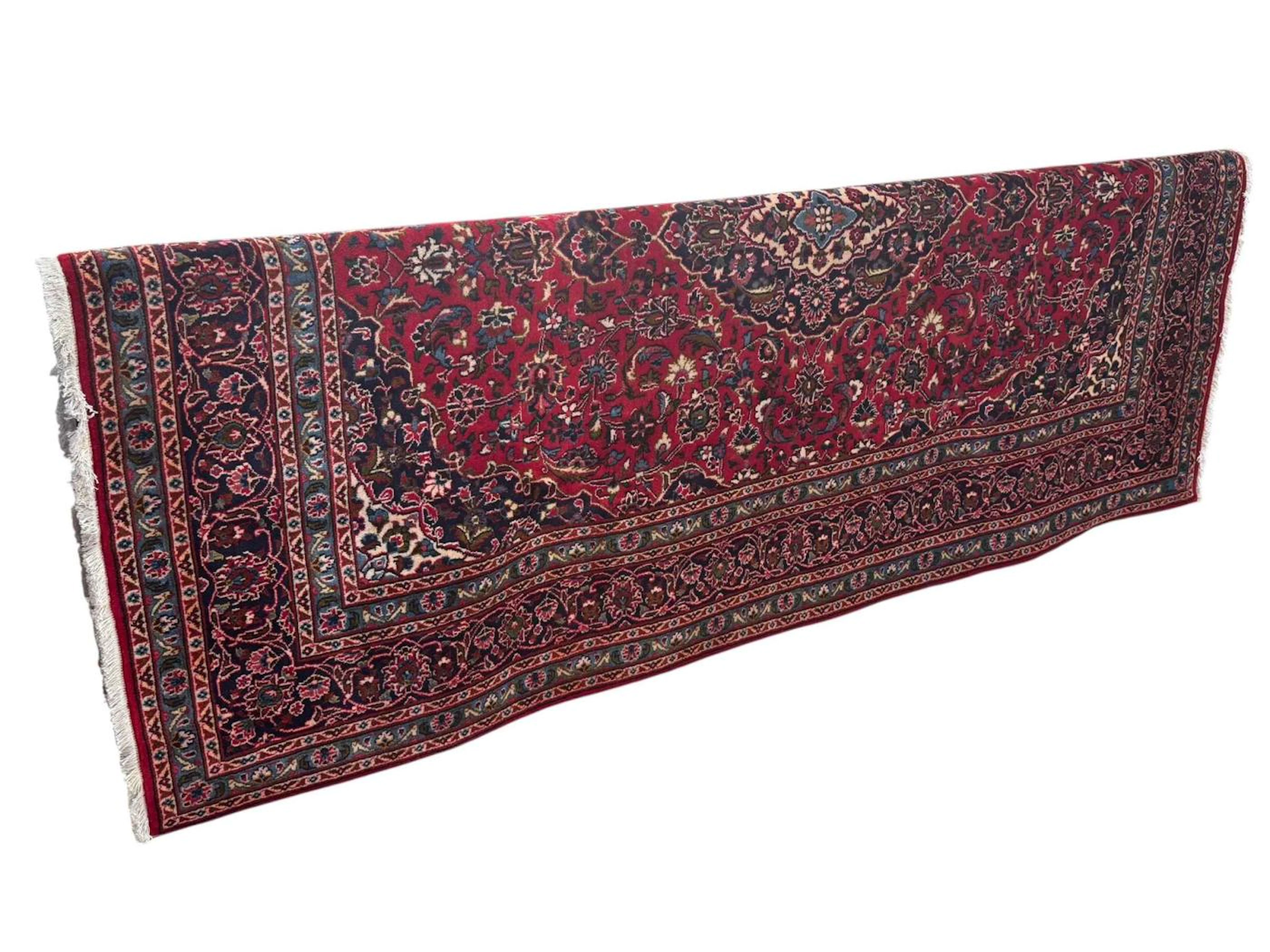 Large fine had knotted red ground Mashad carpet, 310cm by 200cm.