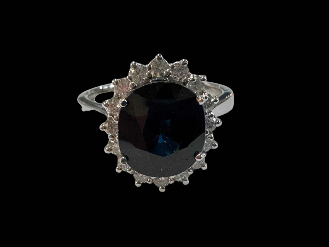 Sapphire and diamond cluster ring set in 18 carat white gold, sapphire