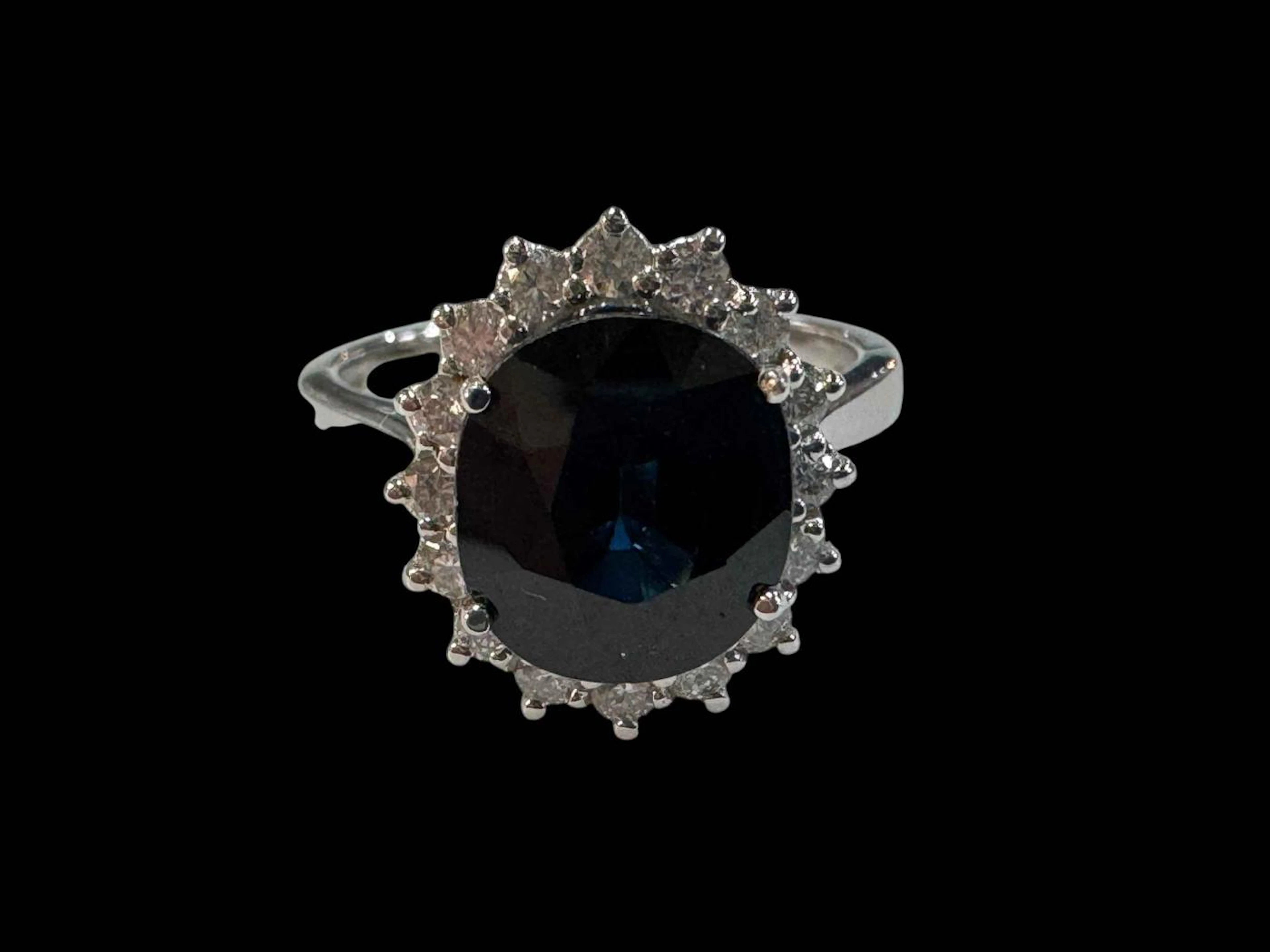 Sapphire and diamond cluster ring set in 18 carat white gold, sapphire
