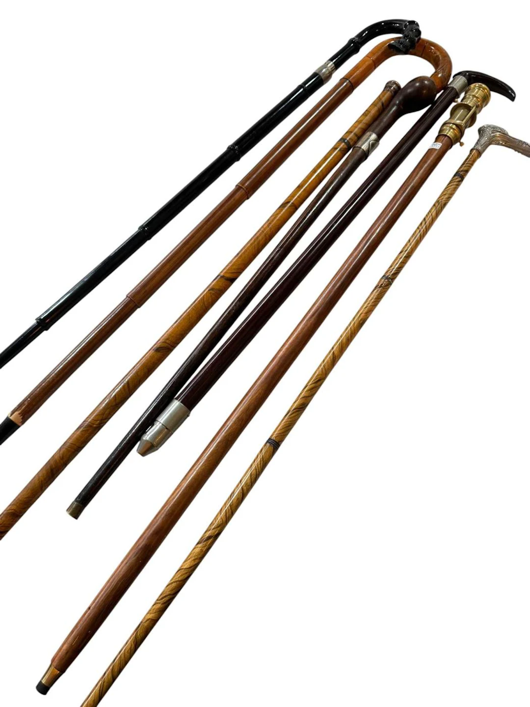 Collection of seven walking sticks including pen pencil cane, two