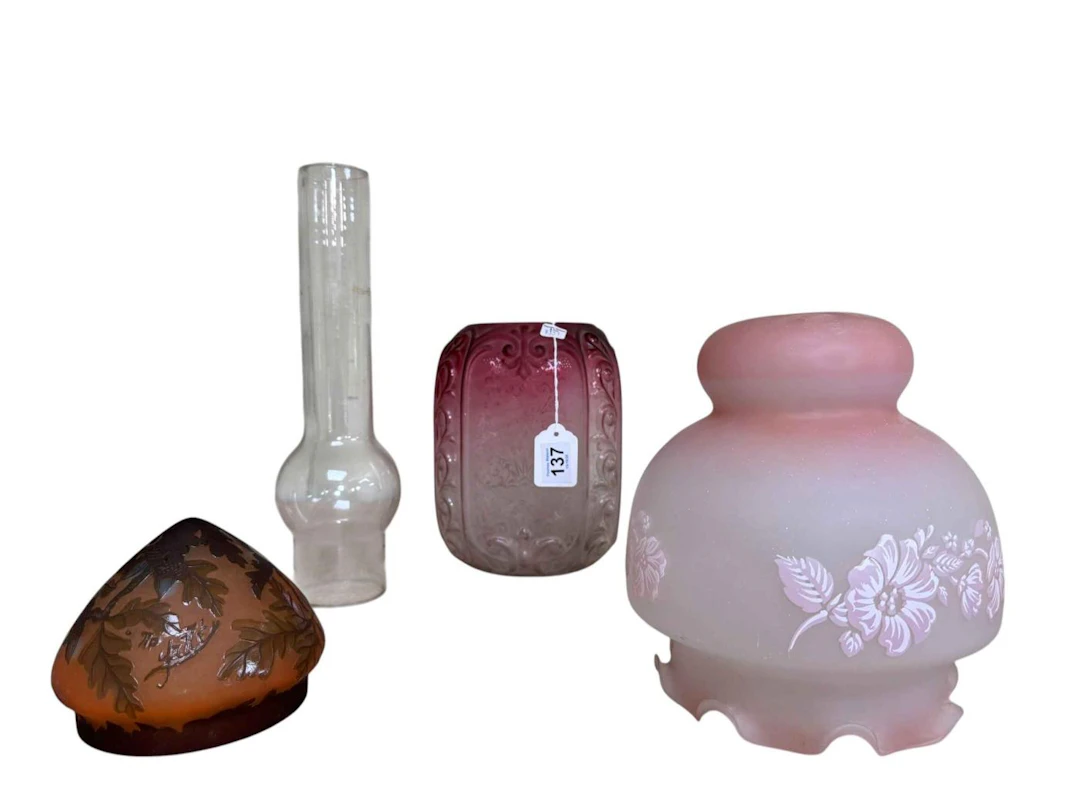Three glass shades including etched ruby glass shade and chimney.