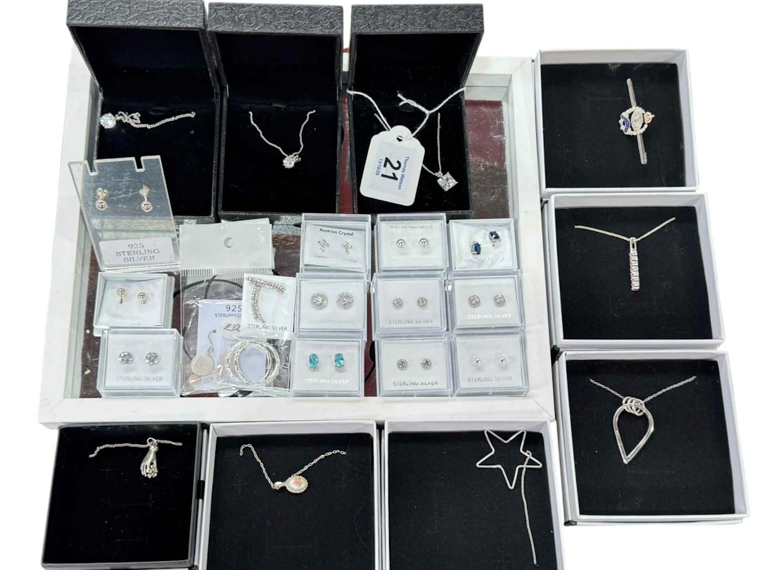 Collection of boxed silver jewellery including pendants and earrings.