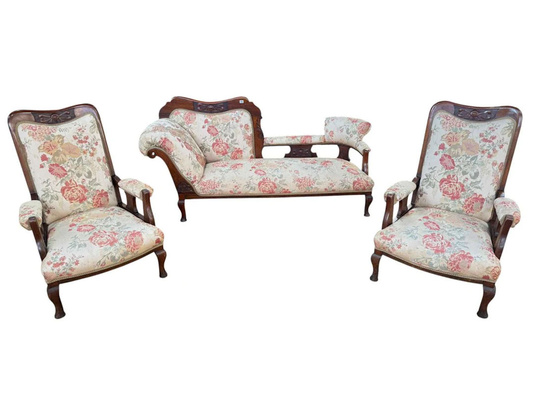 Three piece Edwardian mahogany parlour suite upholstered in floral fabric.