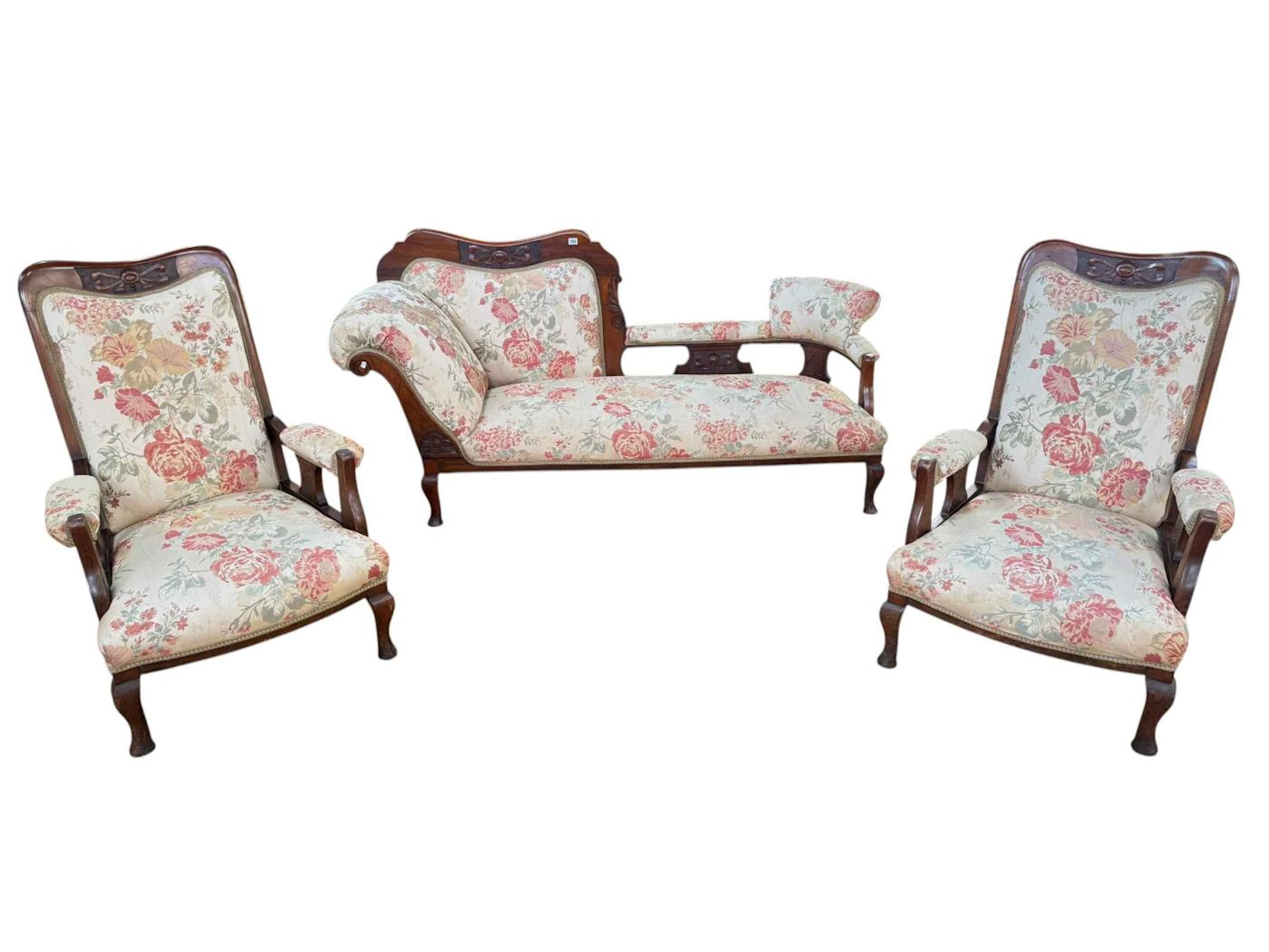 Three piece Edwardian mahogany parlour suite upholstered in floral fabric.