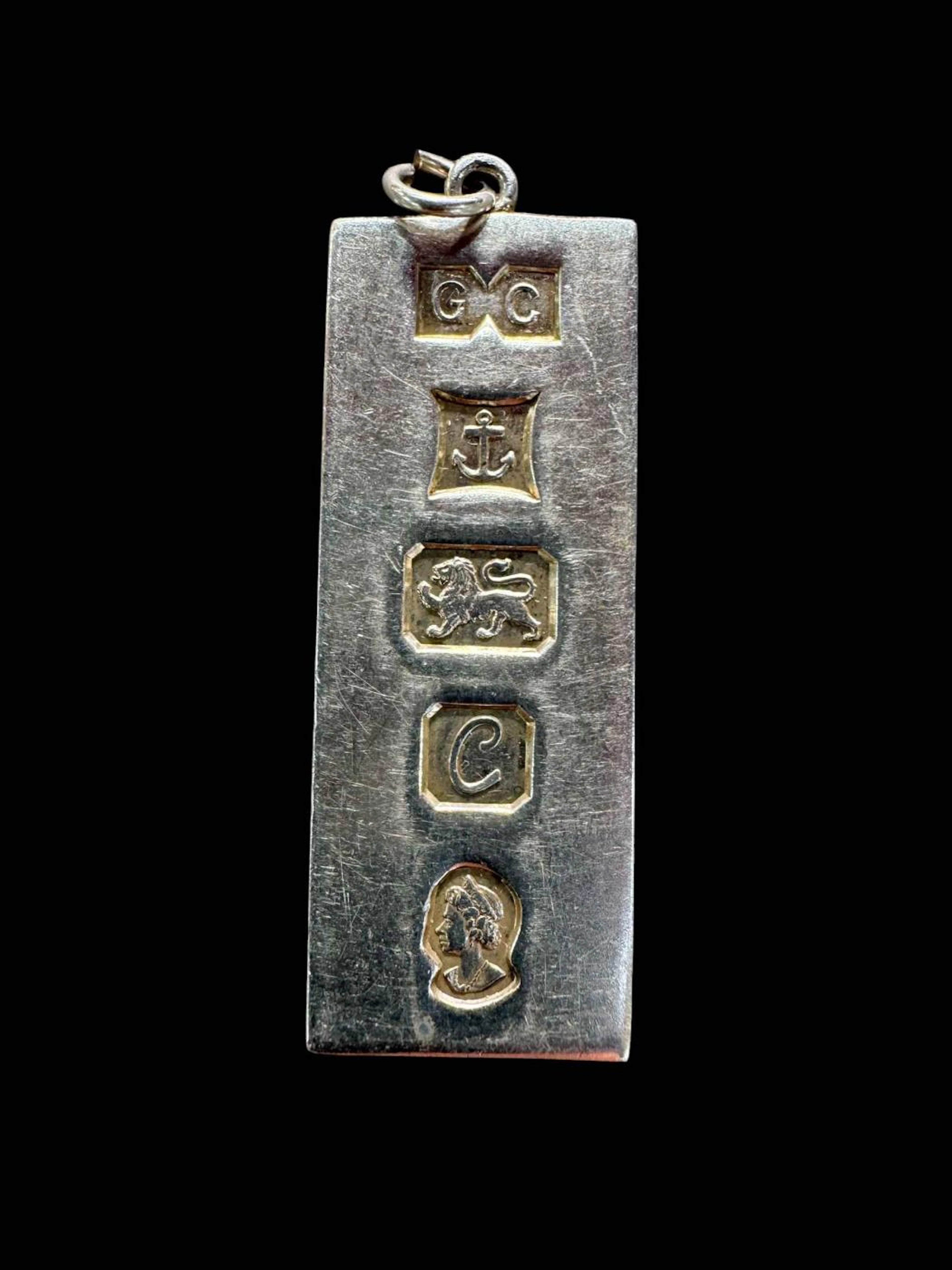 Silver ingot pendant.