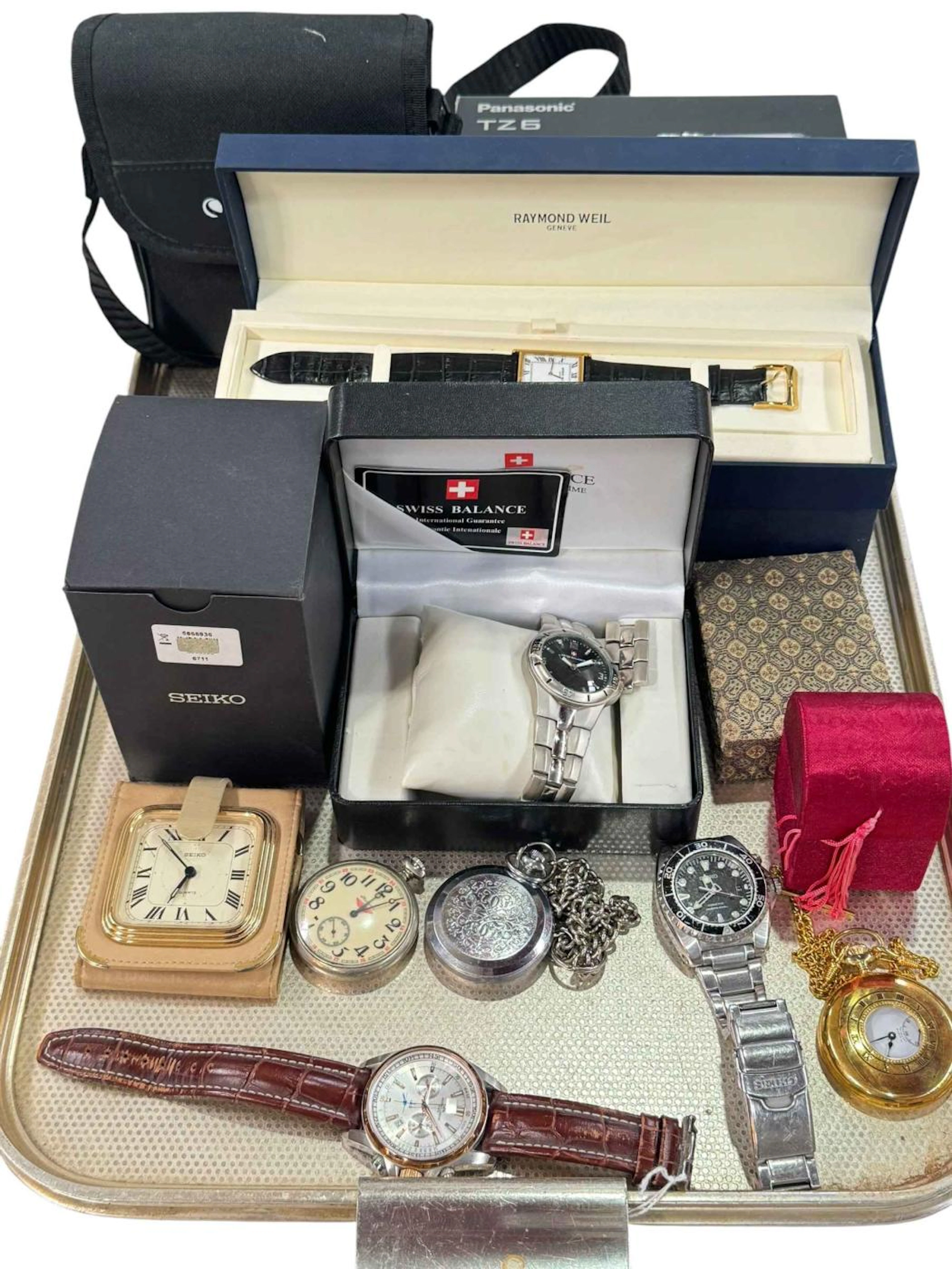 Collection of watches, Lumix camera, and Celestron binoculars.