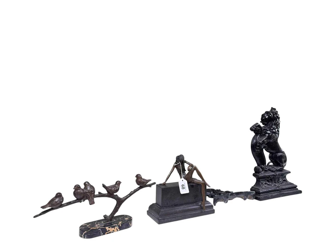 Two Victorian cast iron doorstops and two bronze sculptures on marble bases.