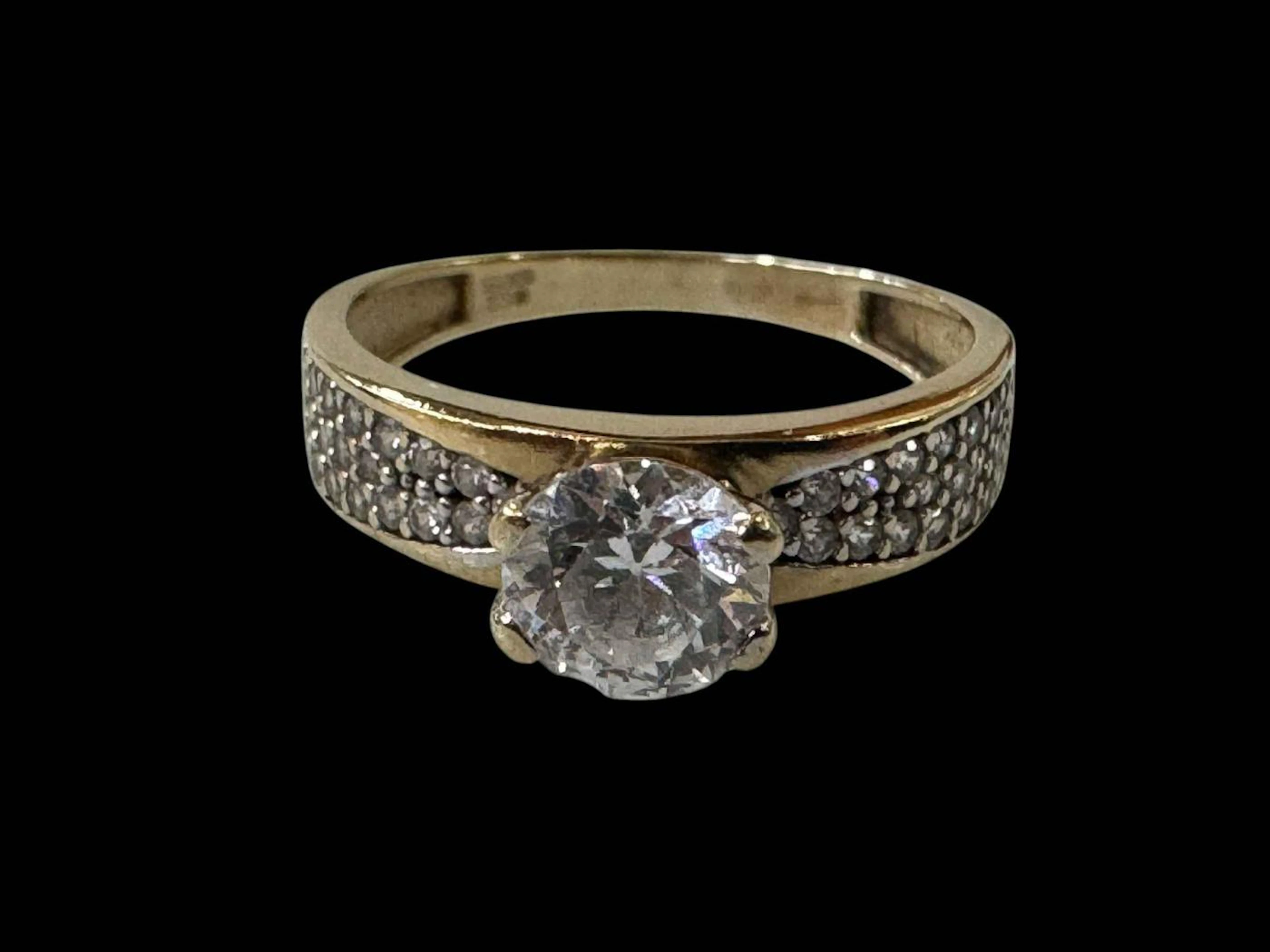 9 carat gold solitaire dress ring with ornate shoulders, size Q.